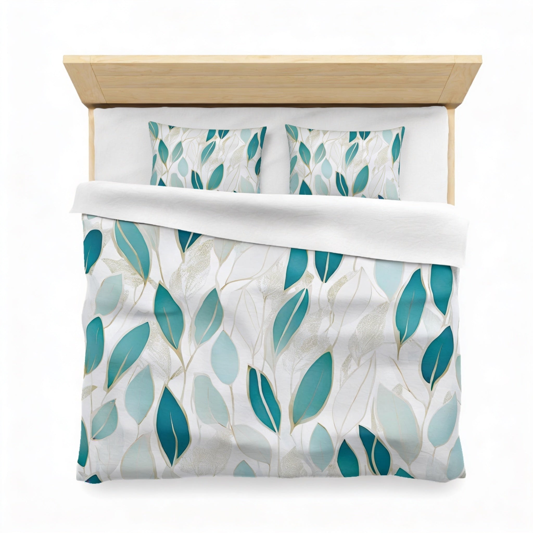 a neatly made bed with a white comforter and a patterned blue and green leaf design. The bed has a wooden headboard and two pillows with a leaf pattern.