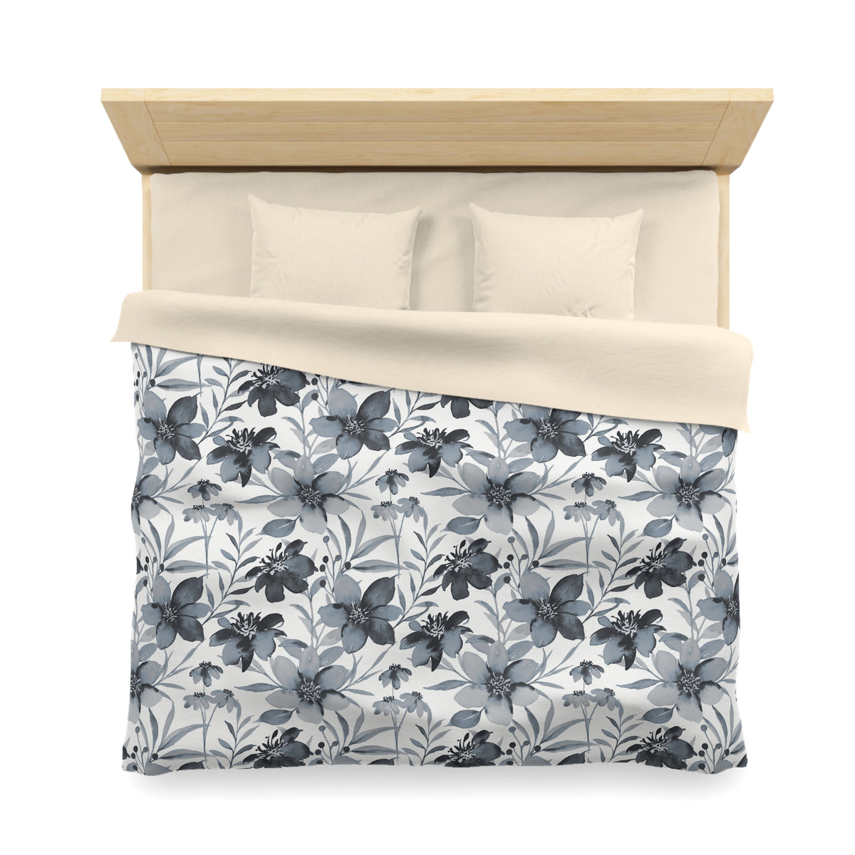 a neatly made bed with a floral patterned comforter and pillows.