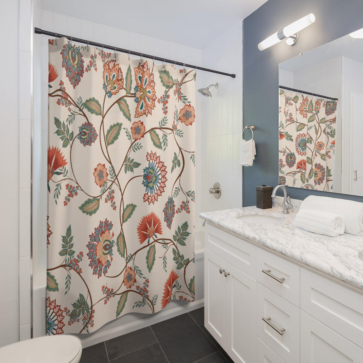 a bathroom with a floral patterned shower curtain, a white vanity with a marble countertop, and a mirror above the vanity.