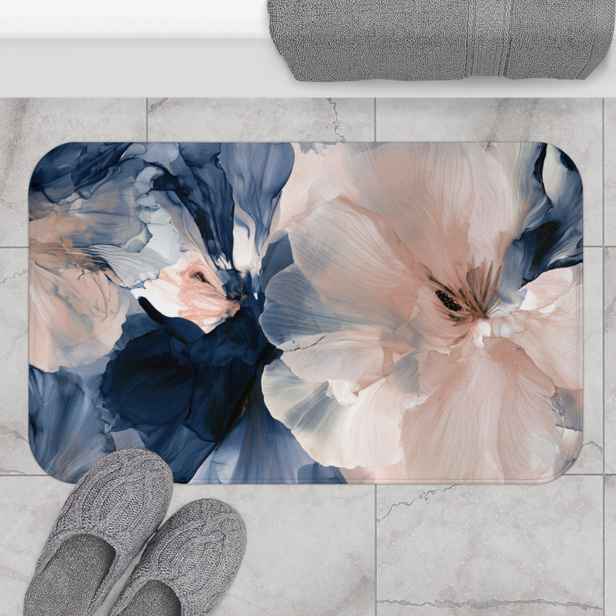 a pair of gray slippers sitting on top of a rug