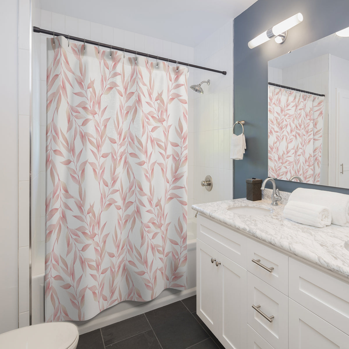 a modern bathroom with a white vanity, a shower curtain with a leaf pattern, and a mirror above the sink.
