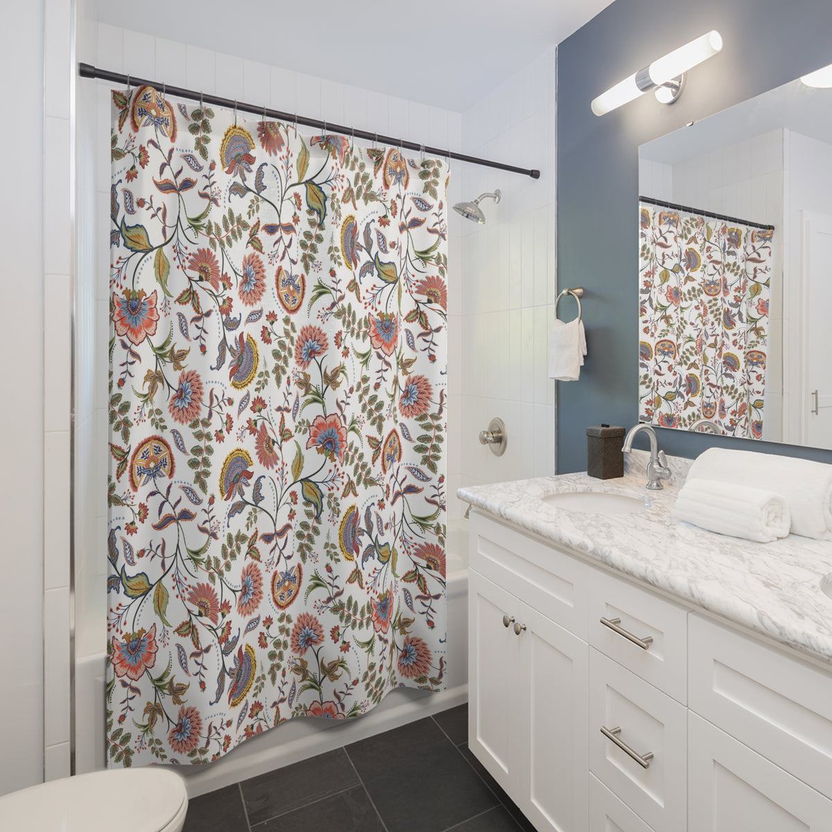 a modern bathroom with a white vanity, a colorful shower curtain, and a mirror above the sink.