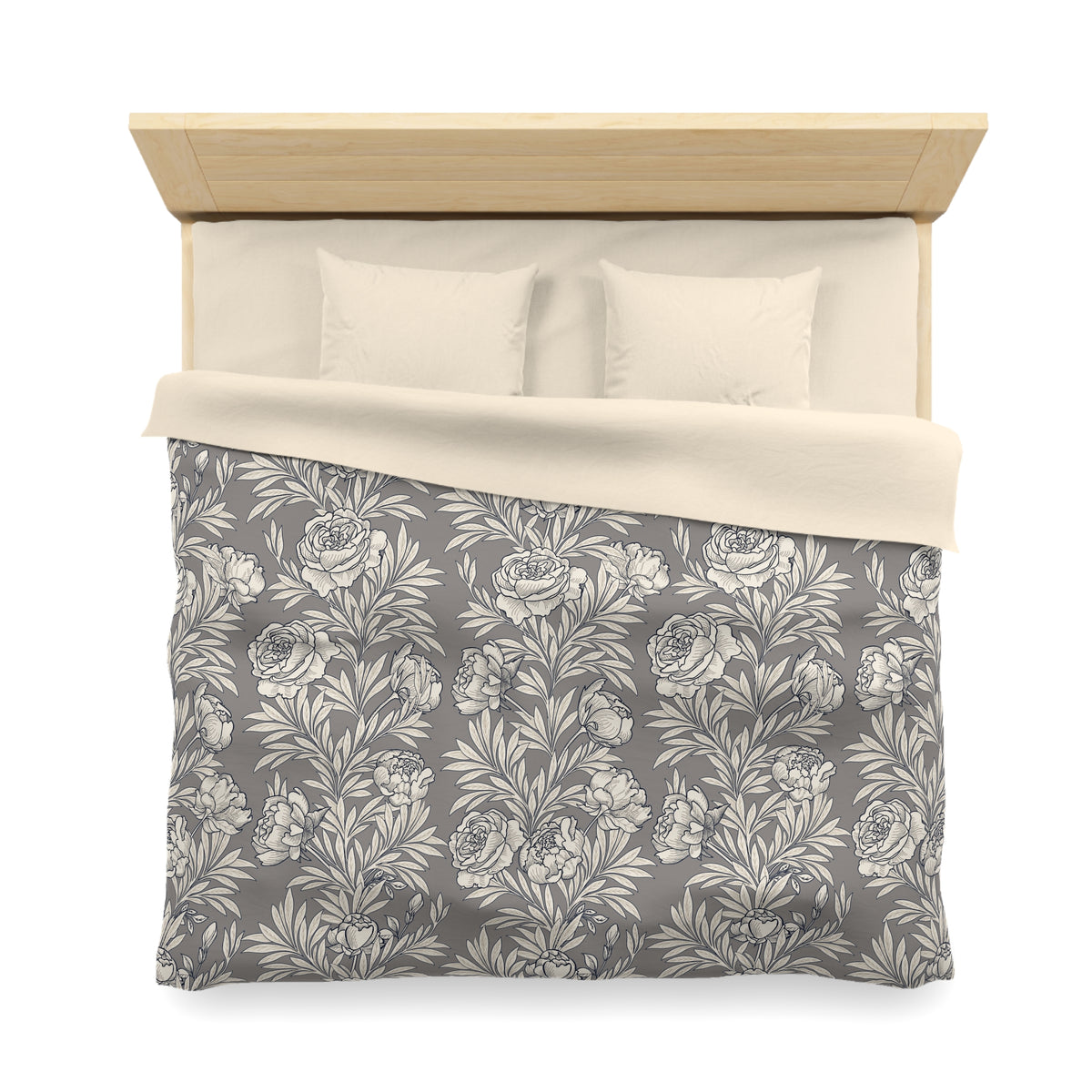 a neatly made bed with a gray and white floral patterned comforter and pillows.