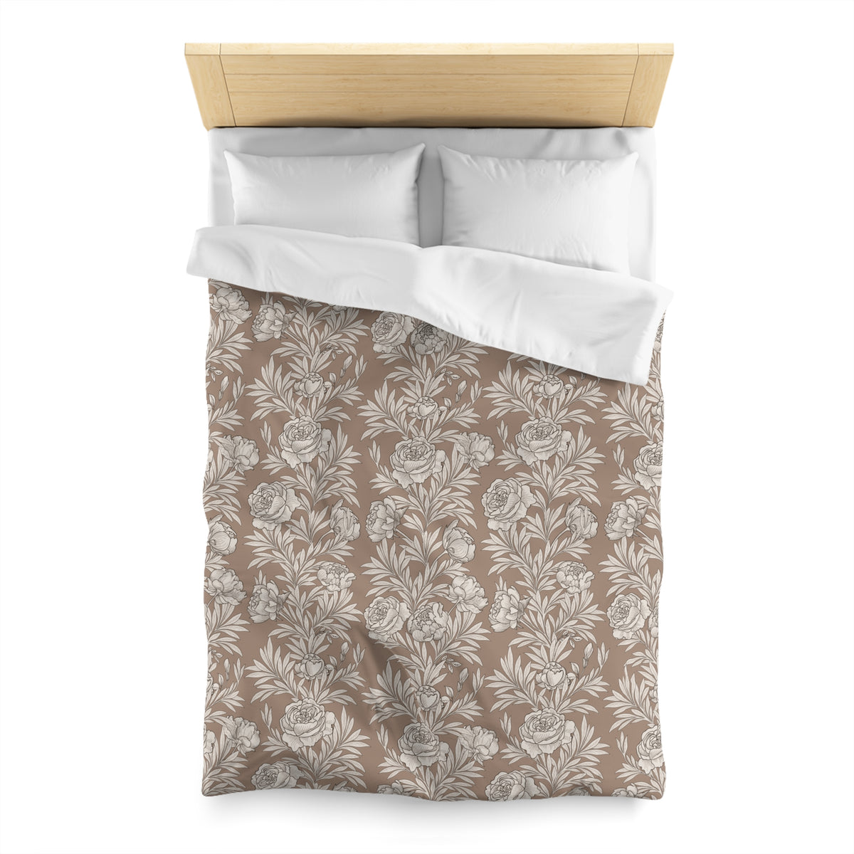 a neatly made bed with a floral patterned comforter and pillows.
