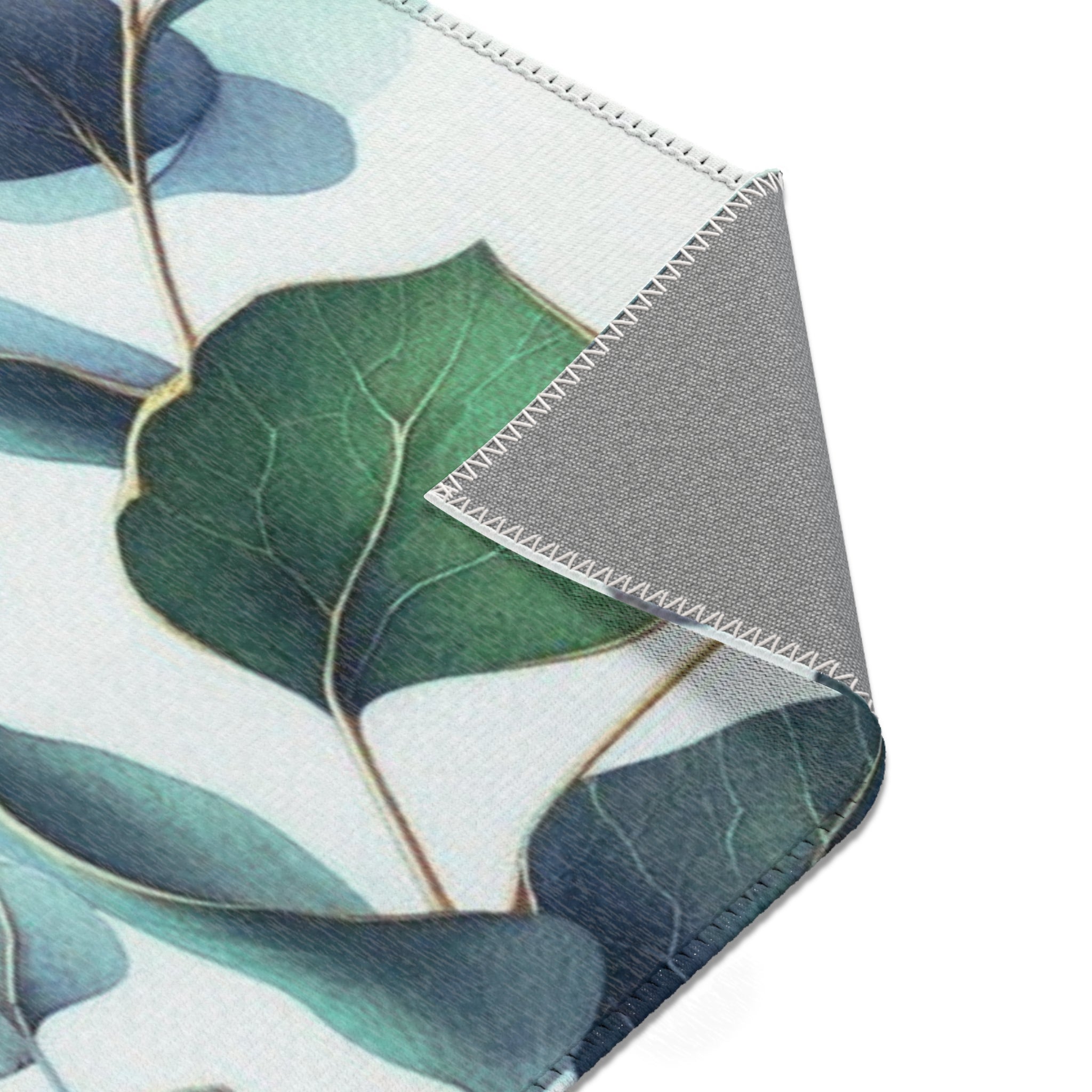 a close-up view of a green leaf with a textured surface, set against a white background.