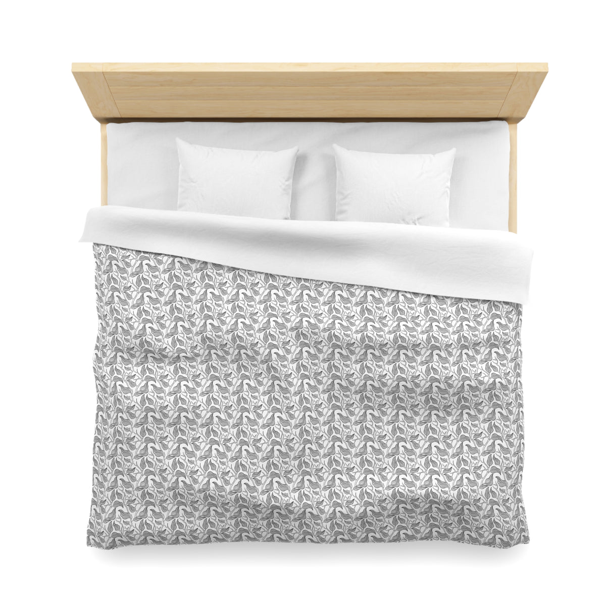 a neatly made bed with a gray and white patterned comforter and two white pillows.