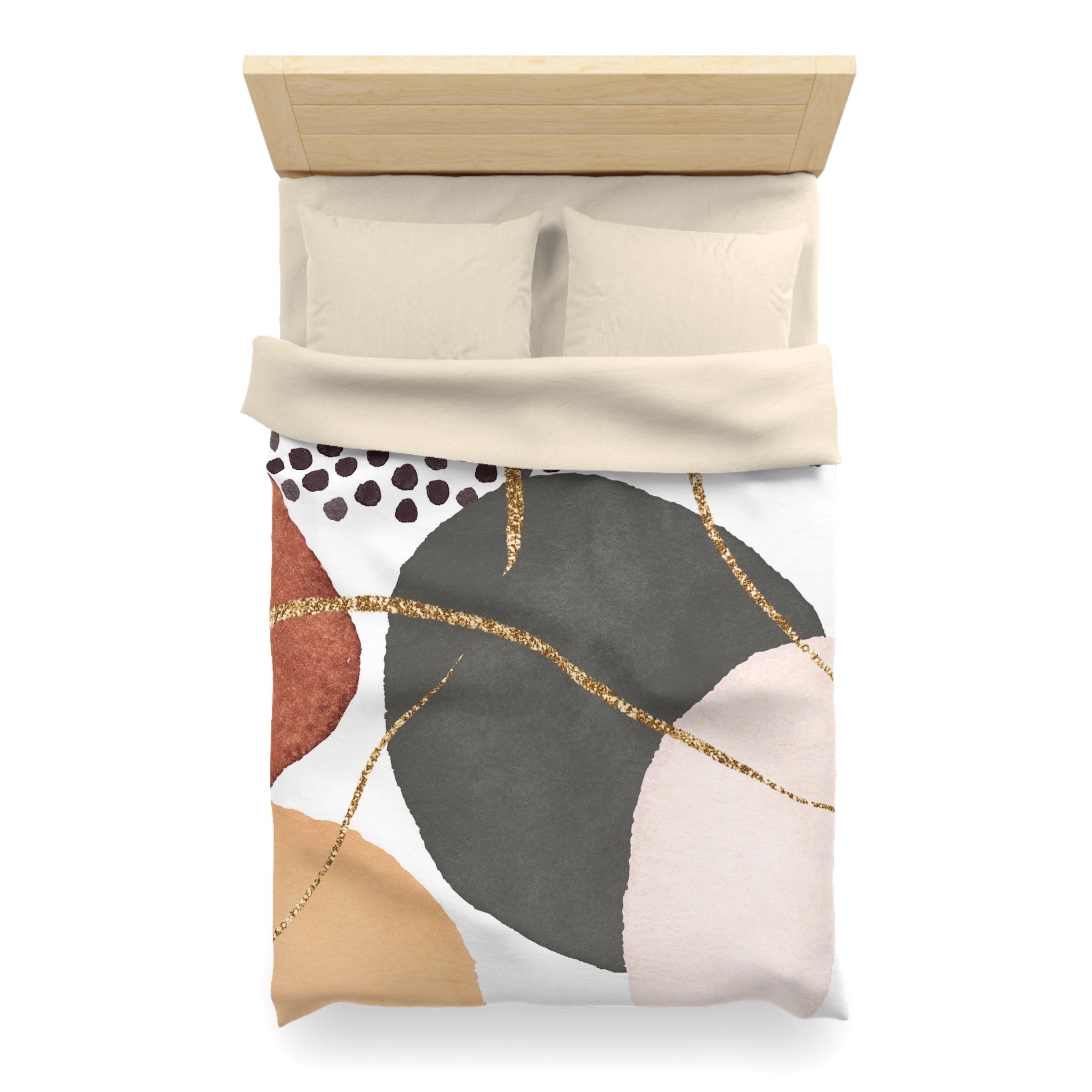 a bed with a colorful abstract pattern on the comforter, featuring a mix of black, white, and gold colors.