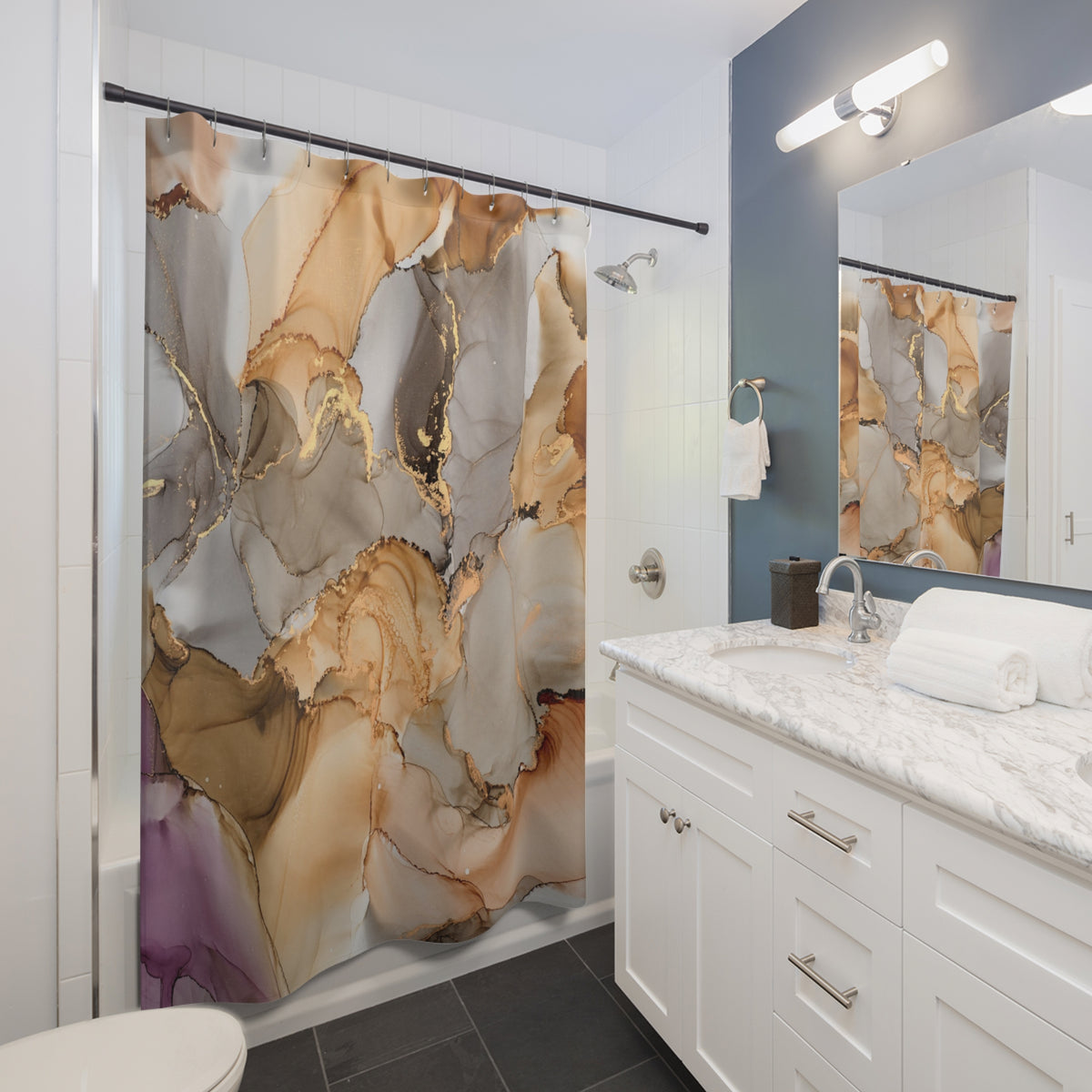 a modern bathroom with a white vanity, marble countertop, and a shower curtain with a marble and gold abstract design.