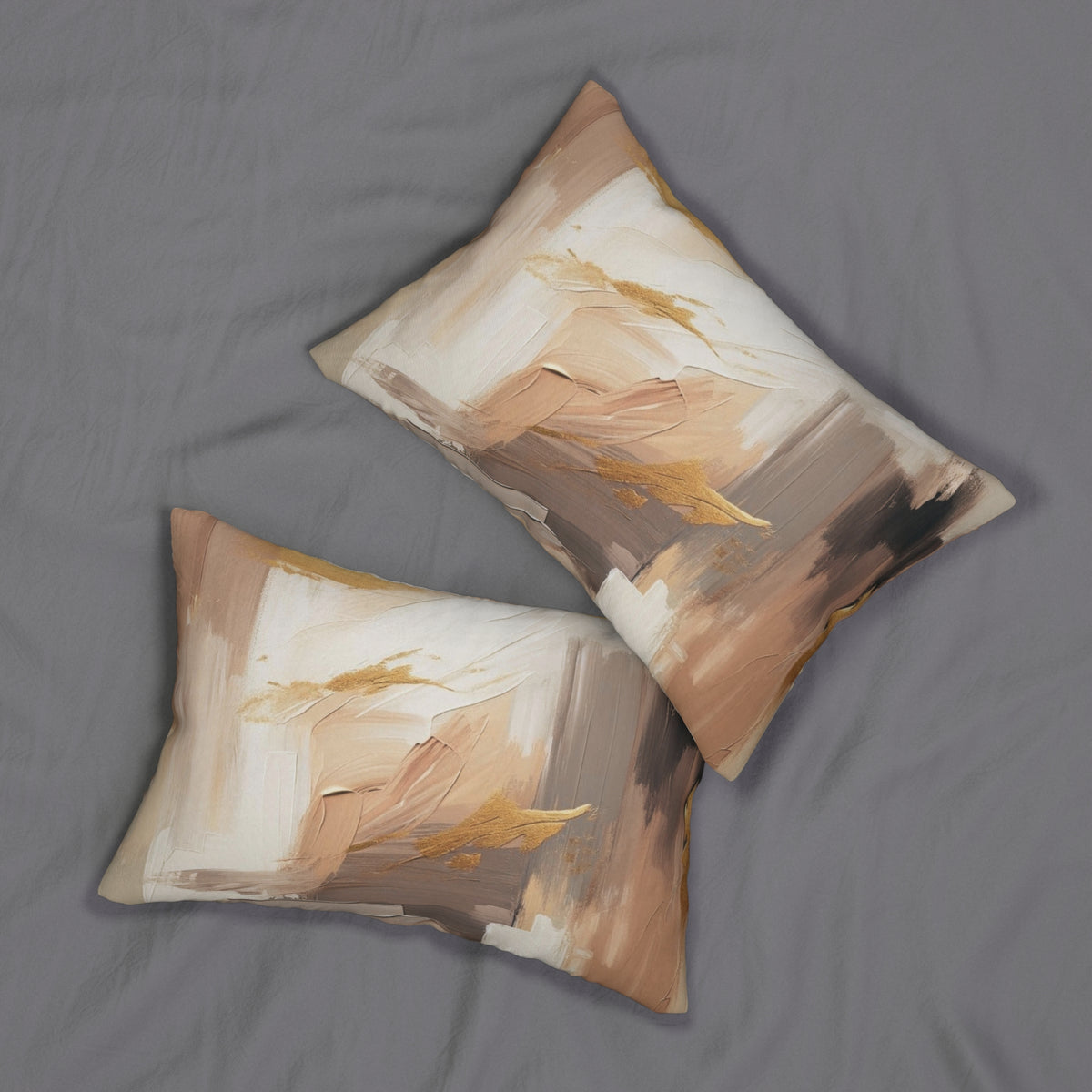 two decorative pillows with abstract art designs on them, placed on a grey fabric surface.