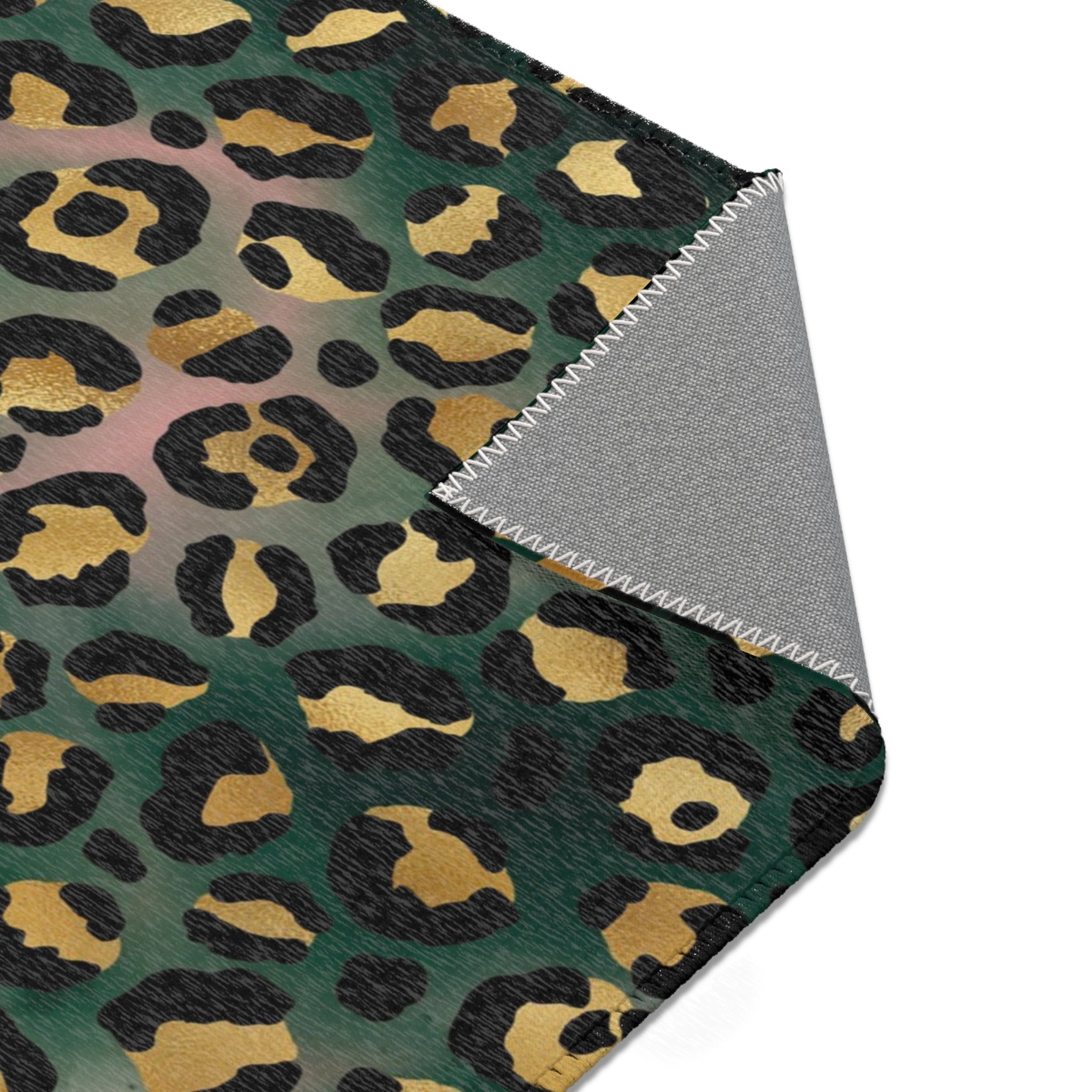 Dark forest green, black and beige leopard animal print large area rug styled with neutral decor