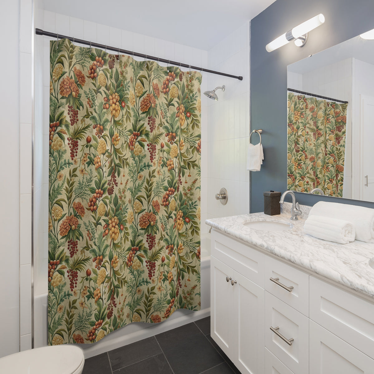 a bathroom with a shower curtain featuring a tropical print of various fruits and flowers. The bathroom has white cabinets, a marble countertop, and a sink with a mirror above it.