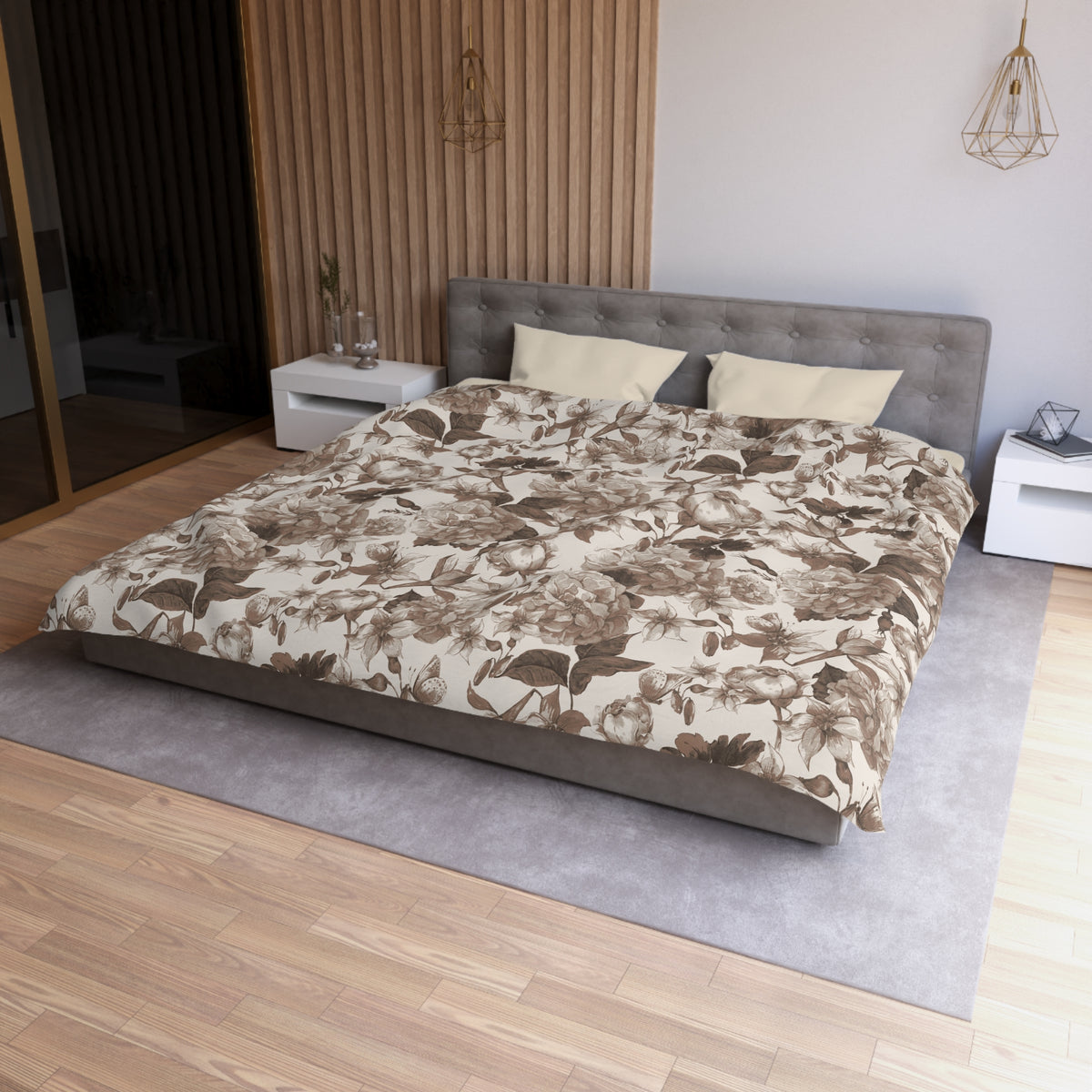 a modern bedroom with a large bed, a gray headboard, and a floral patterned comforter. The room has a wooden floor and white walls, creating a serene and elegant atmosphere.