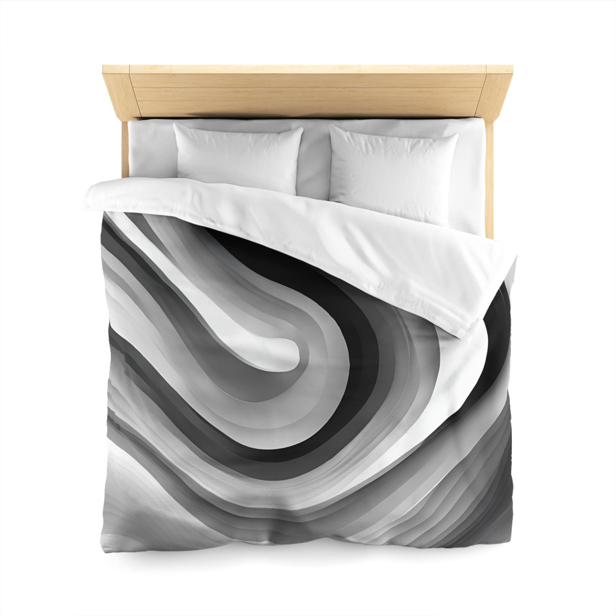a bed with a black and white abstract patterned comforter and pillows.