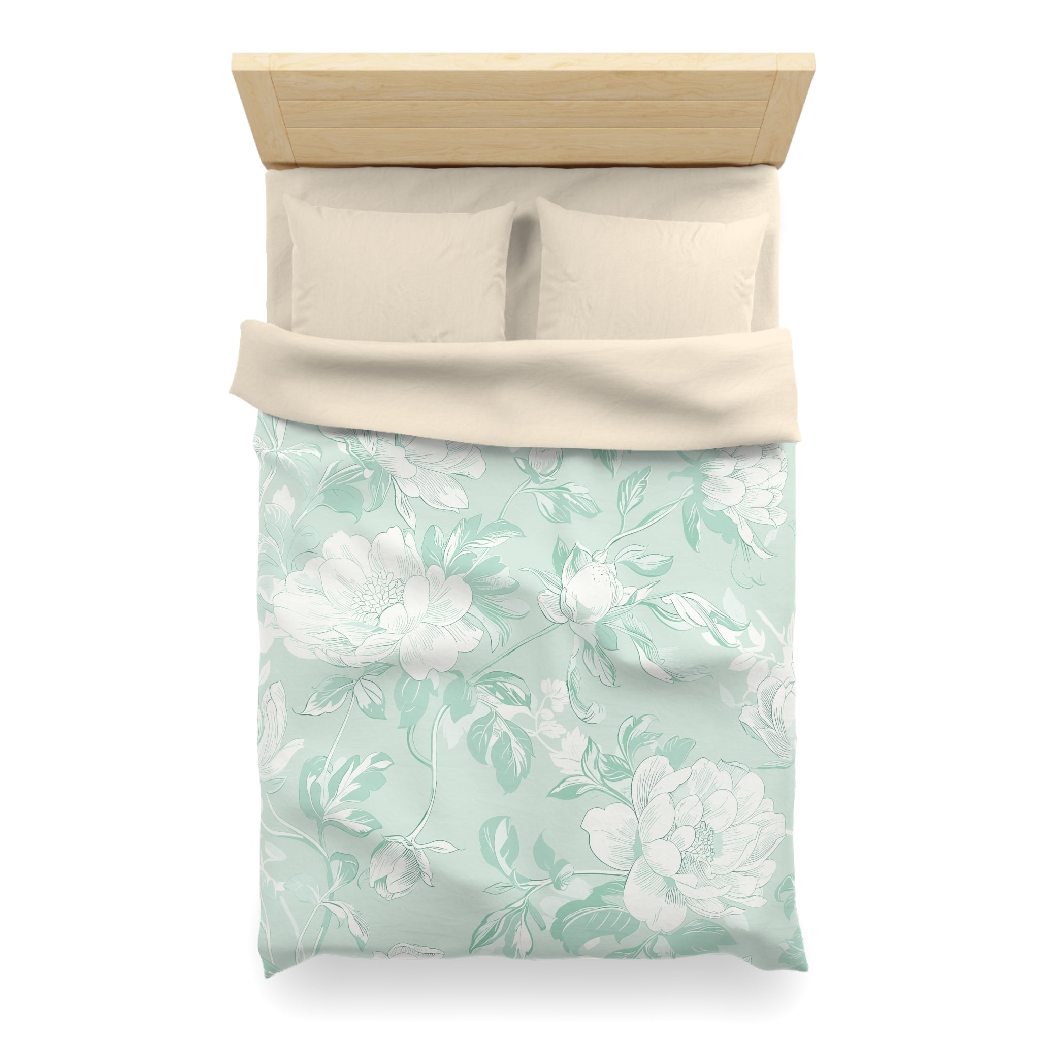 A neatly made bed with a floral patterned comforter and pillows.