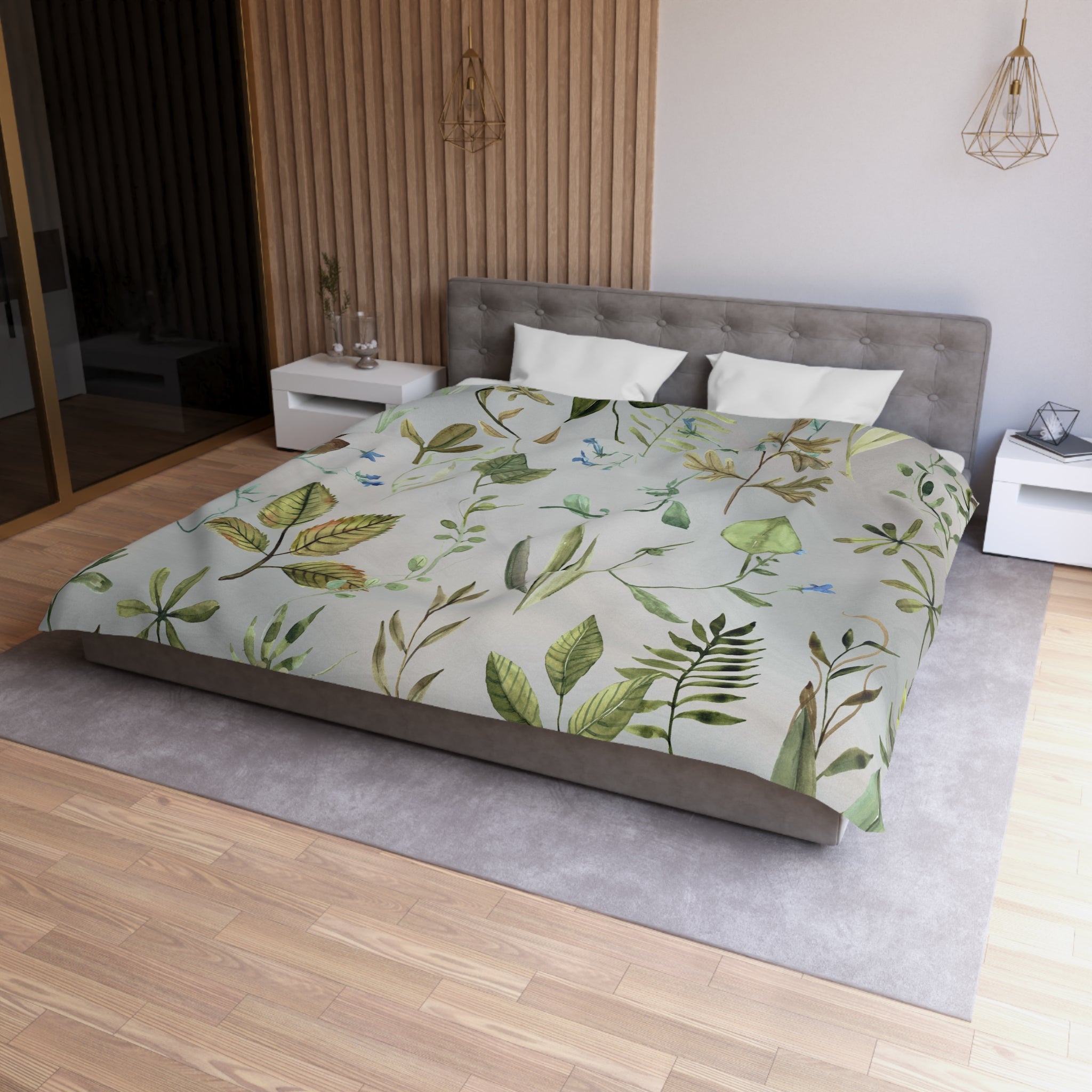 a modern bedroom with a large bed covered in a green and white leaf-patterned comforter. The bed is positioned against a wall with a wooden panel. The room also features a nightstand, a pendant light, and a rug on the floor.