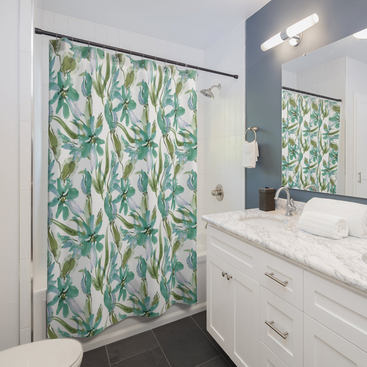 a modern bathroom with a white vanity, a shower curtain with a tropical print, and a mirror above the vanity.