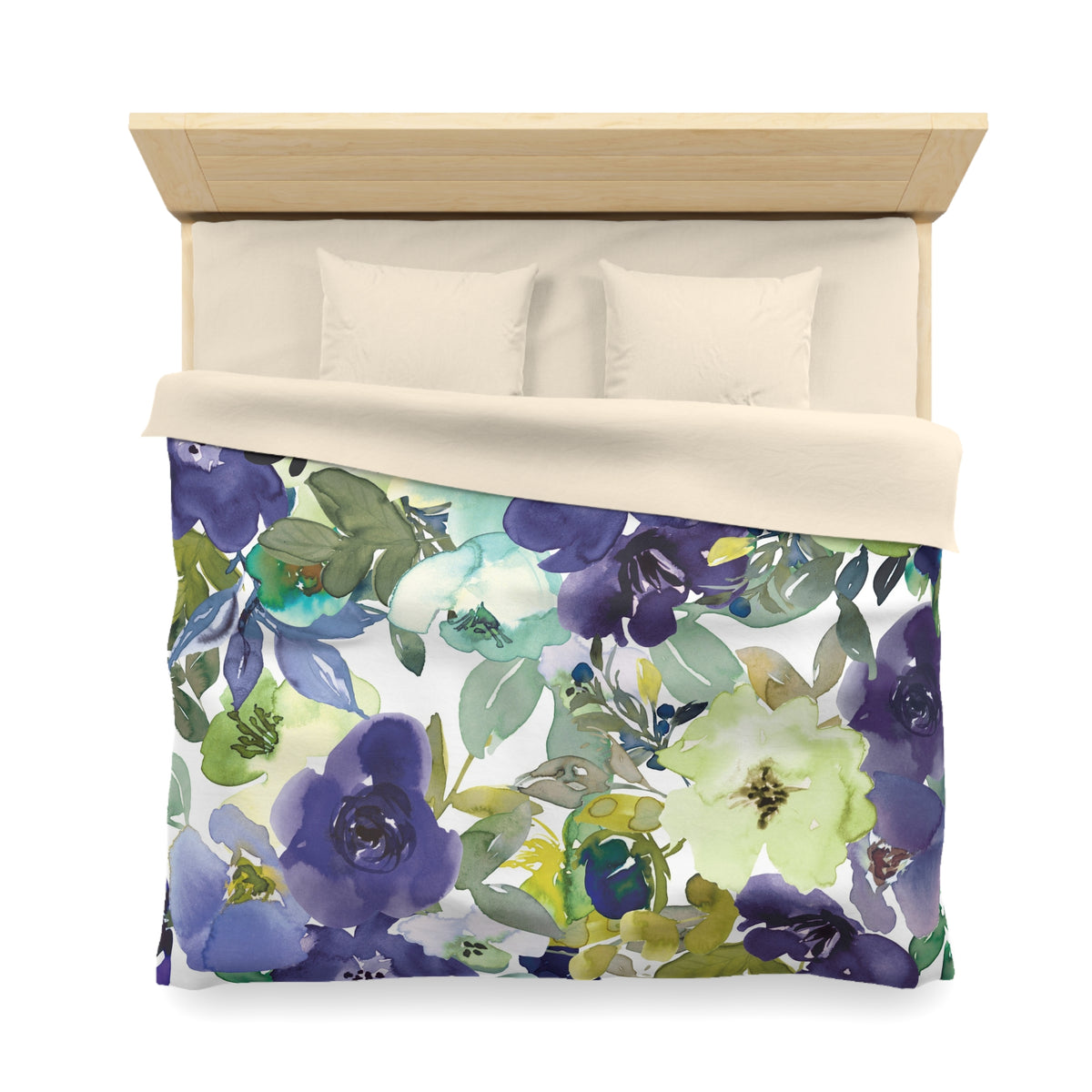 a bed with a floral print duvet cover and pillows.