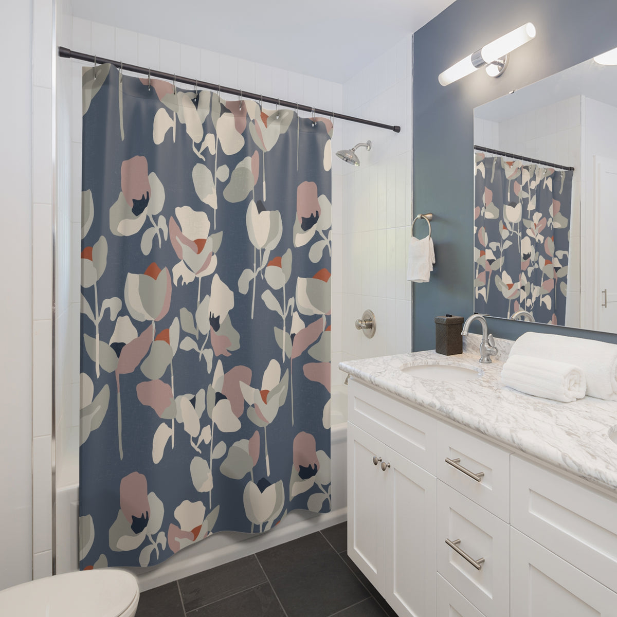 a modern bathroom with a white vanity, a shower curtain with a floral pattern, and a mirror above the vanity.