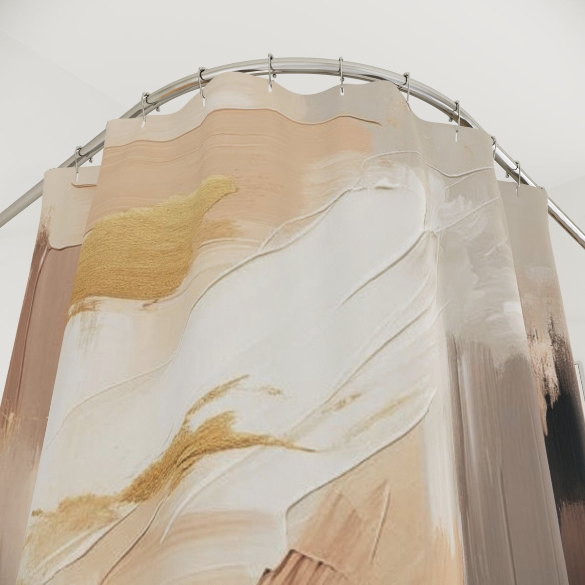 a shower curtain with a large abstract design in shades of beige and white, with a gold-colored element.