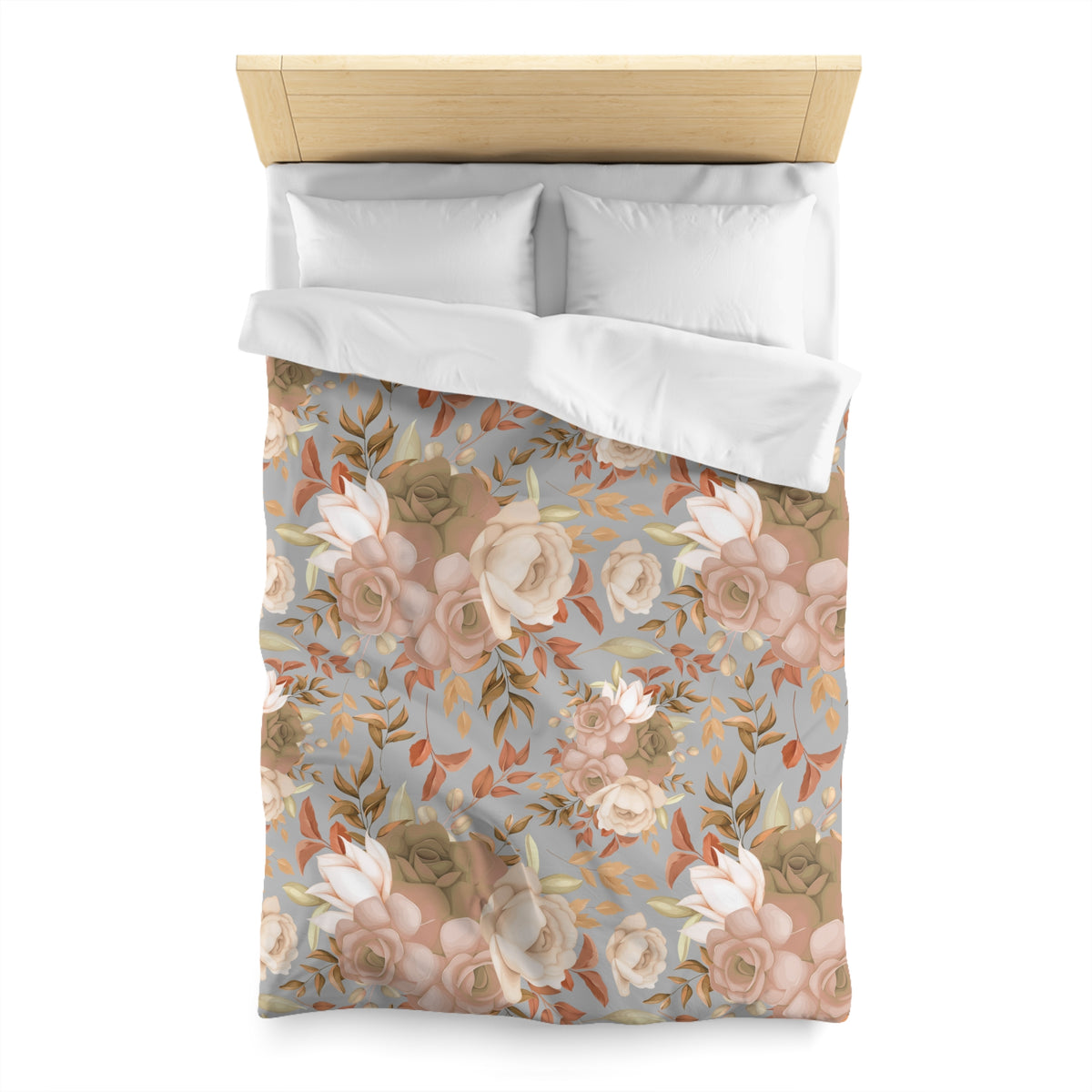 a bed with a floral patterned comforter and pillows.