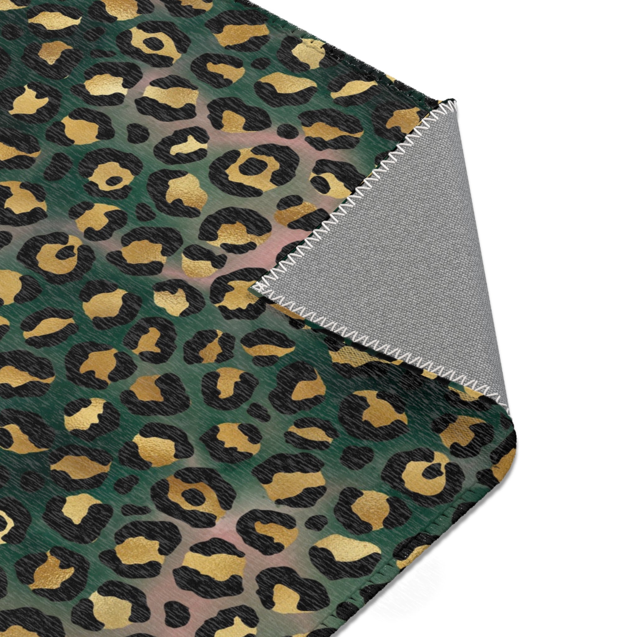 Dark forest green, black and beige leopard animal print large area rug shown under furniture in a styled room