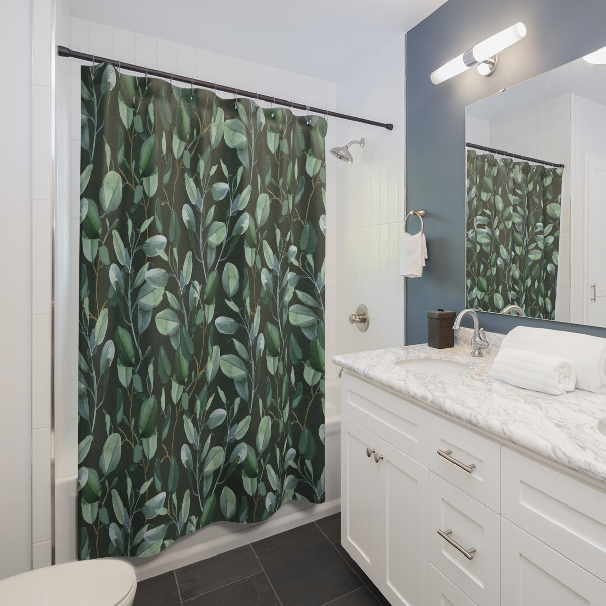 a modern bathroom with a white vanity, a green shower curtain with a leaf pattern, and a mirror above the vanity.
