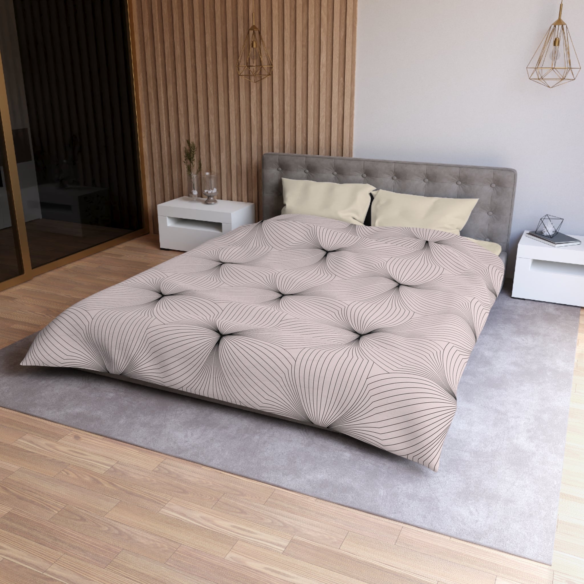 a modern bedroom with a large bed, a gray headboard, and a patterned comforter. The room has a wooden floor and white walls, creating a clean and minimalist aesthetic.