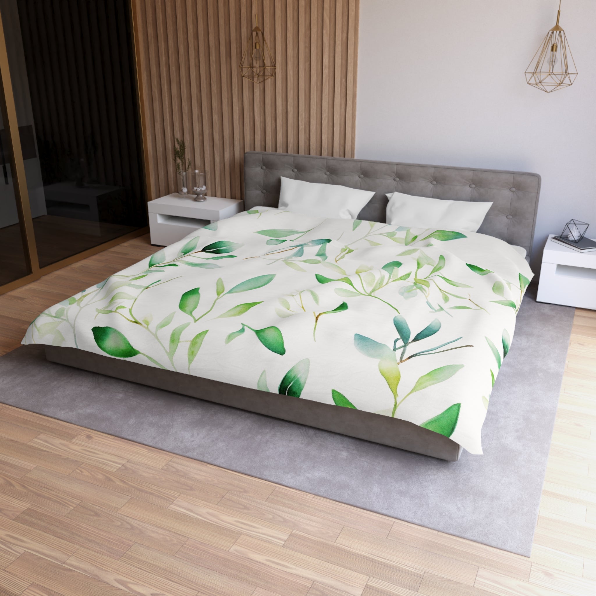 a modern bedroom with a large bed covered in a white comforter featuring a leafy green pattern. The bed is positioned against a wall with a wooden panel. The room also includes a nightstand, a pendant light, and a rug on the floor.