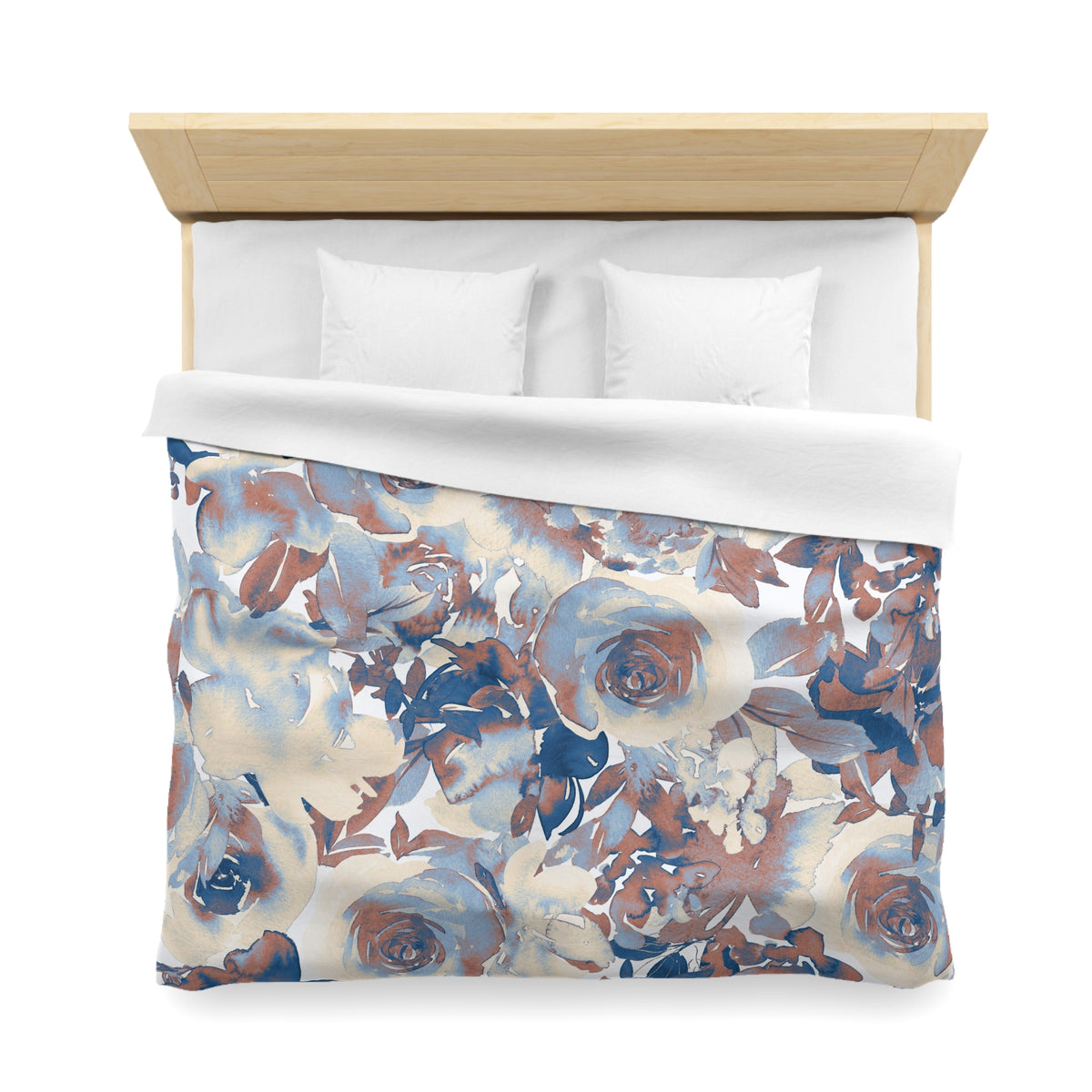 a bed with a floral print duvet cover and white pillows.