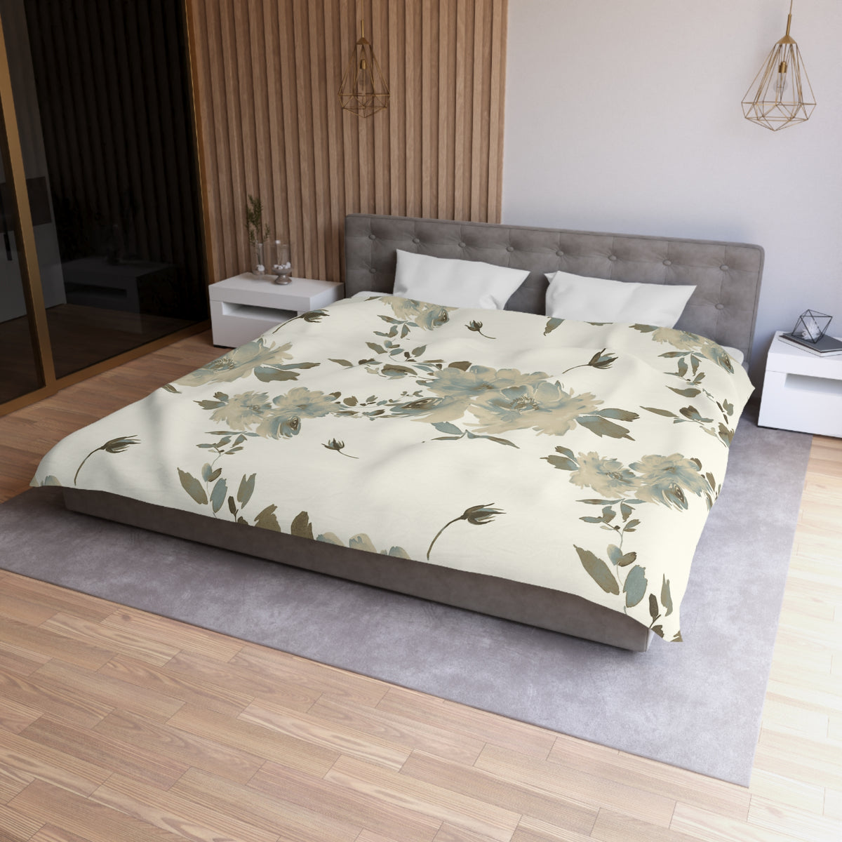 a modern bedroom with a large bed, a gray headboard, and a floral print bedspread. The room has a wooden floor and white walls, creating a serene and elegant atmosphere.