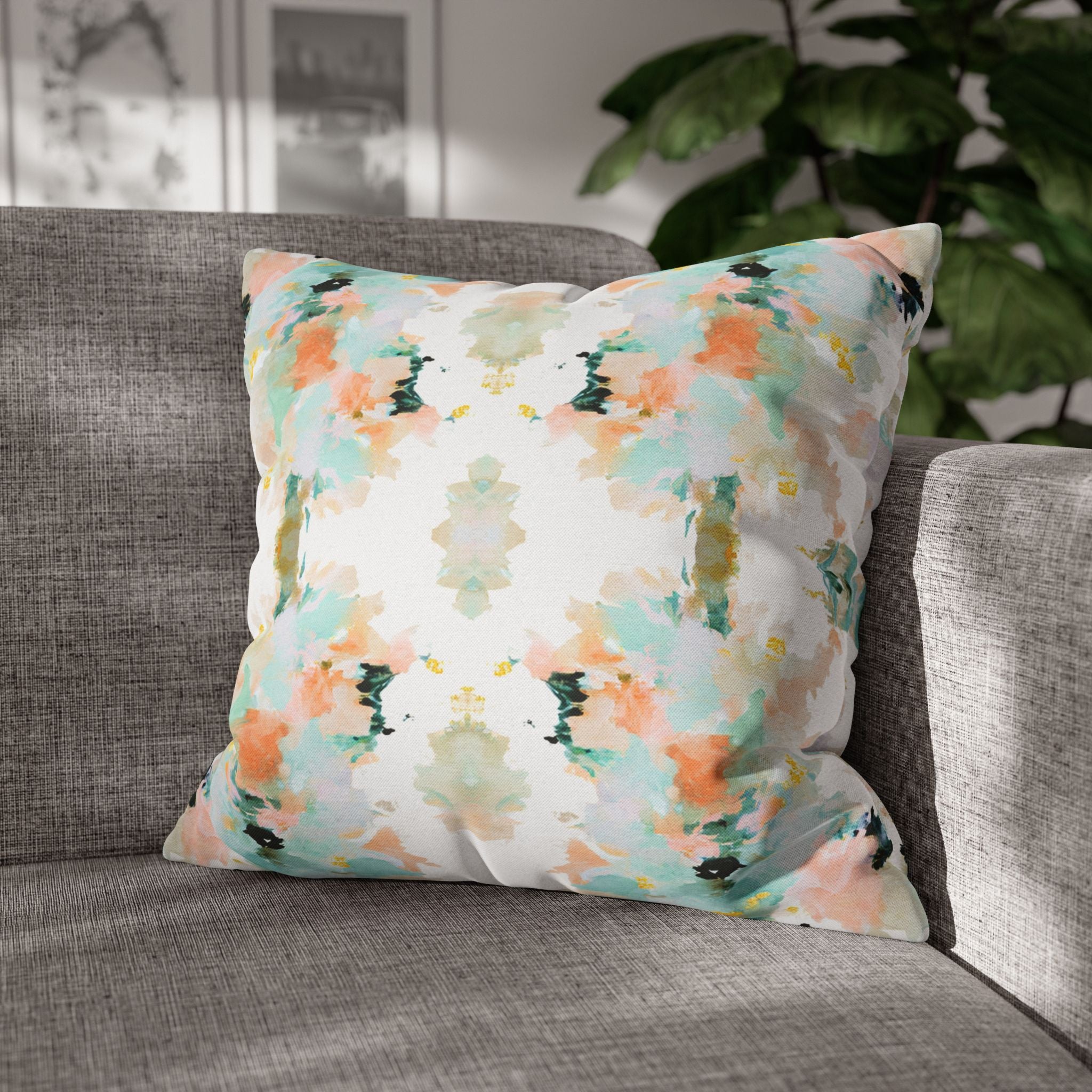 a gray couch with a colorful throw pillow on it.