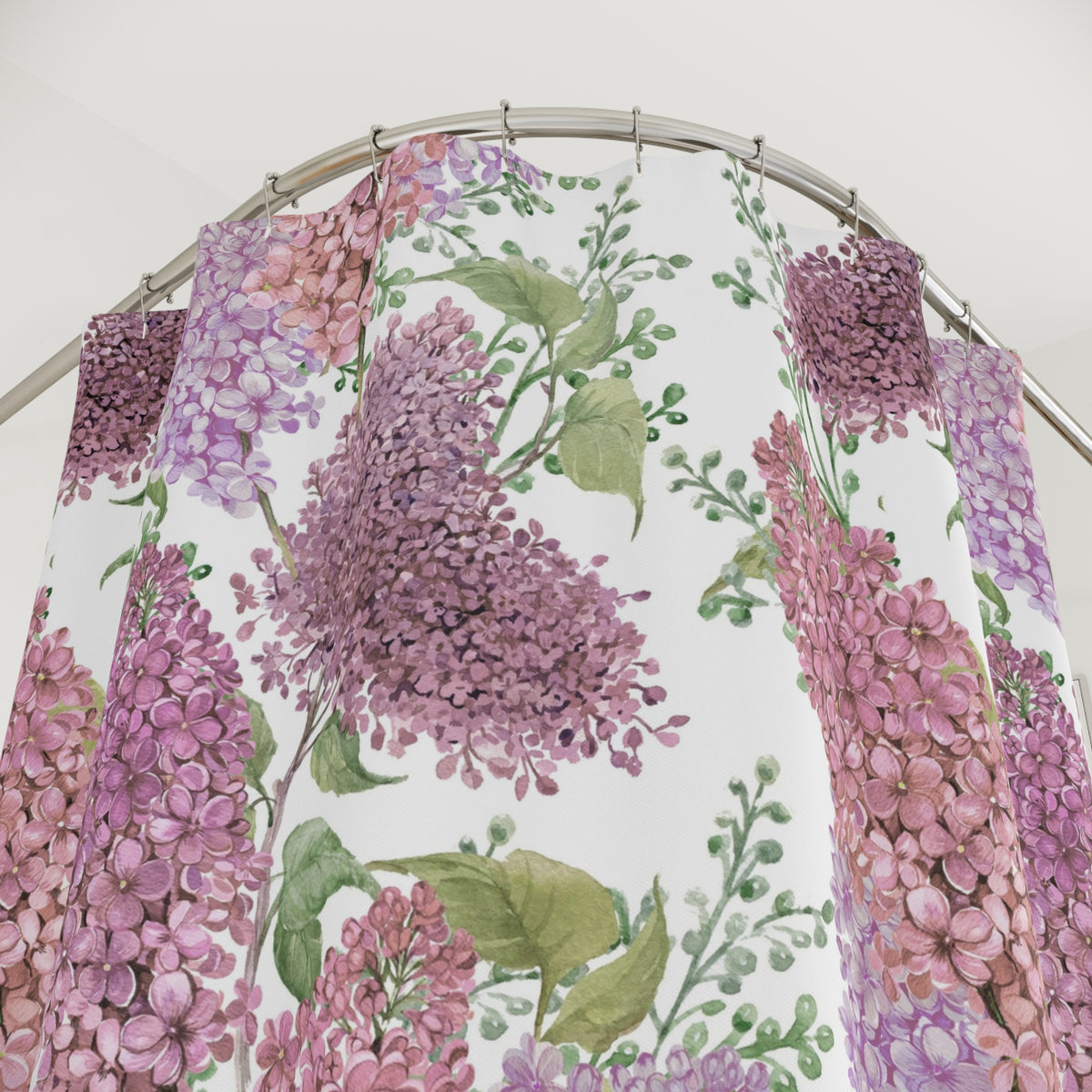 a shower curtain with a floral pattern of purple and green flowers, including lilies and leaves.
