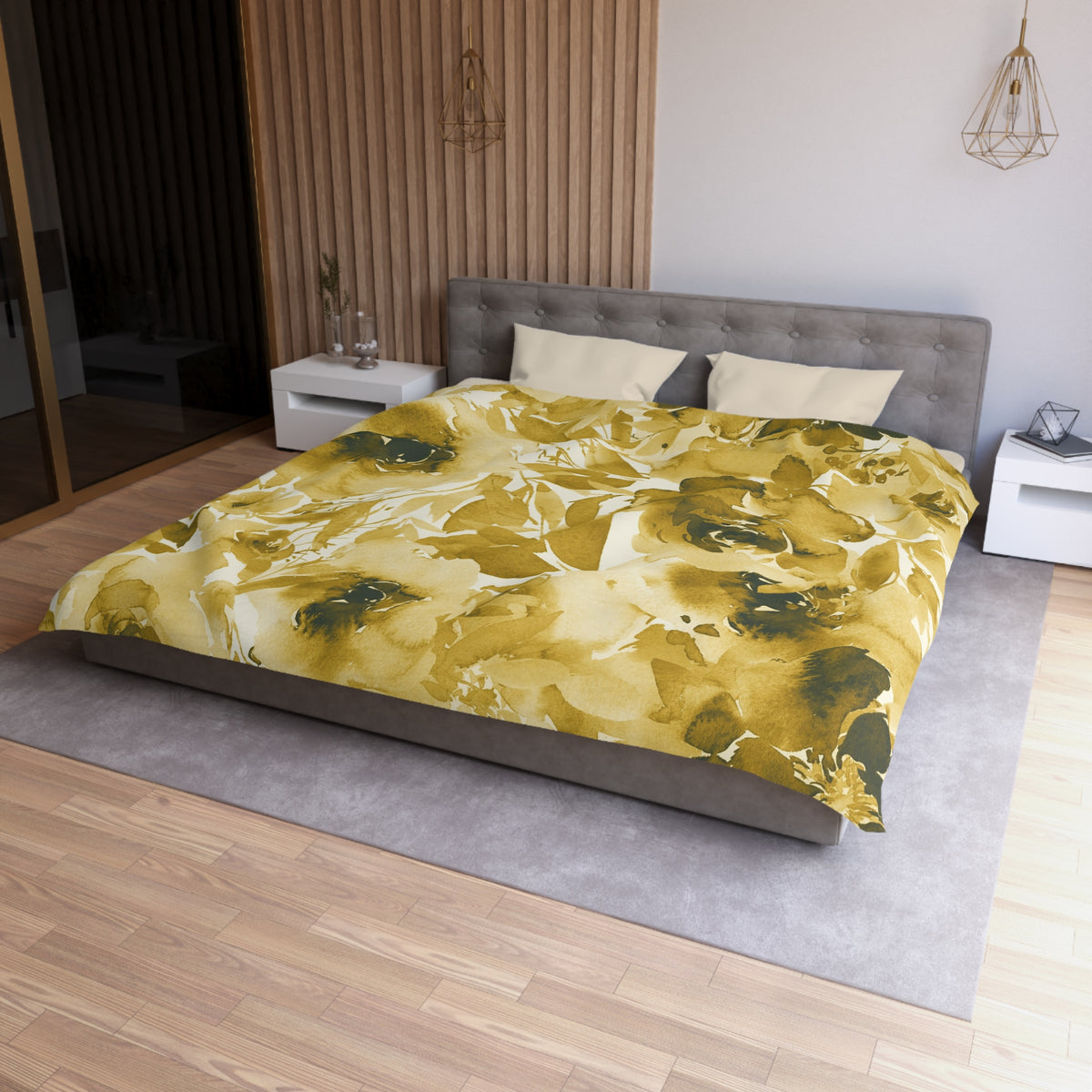a modern bedroom with a large bed covered in a yellow and green floral comforter. The bed is positioned against a wall with a wooden panel. The room also features a nightstand, a pendant light, and a vase on a surface.