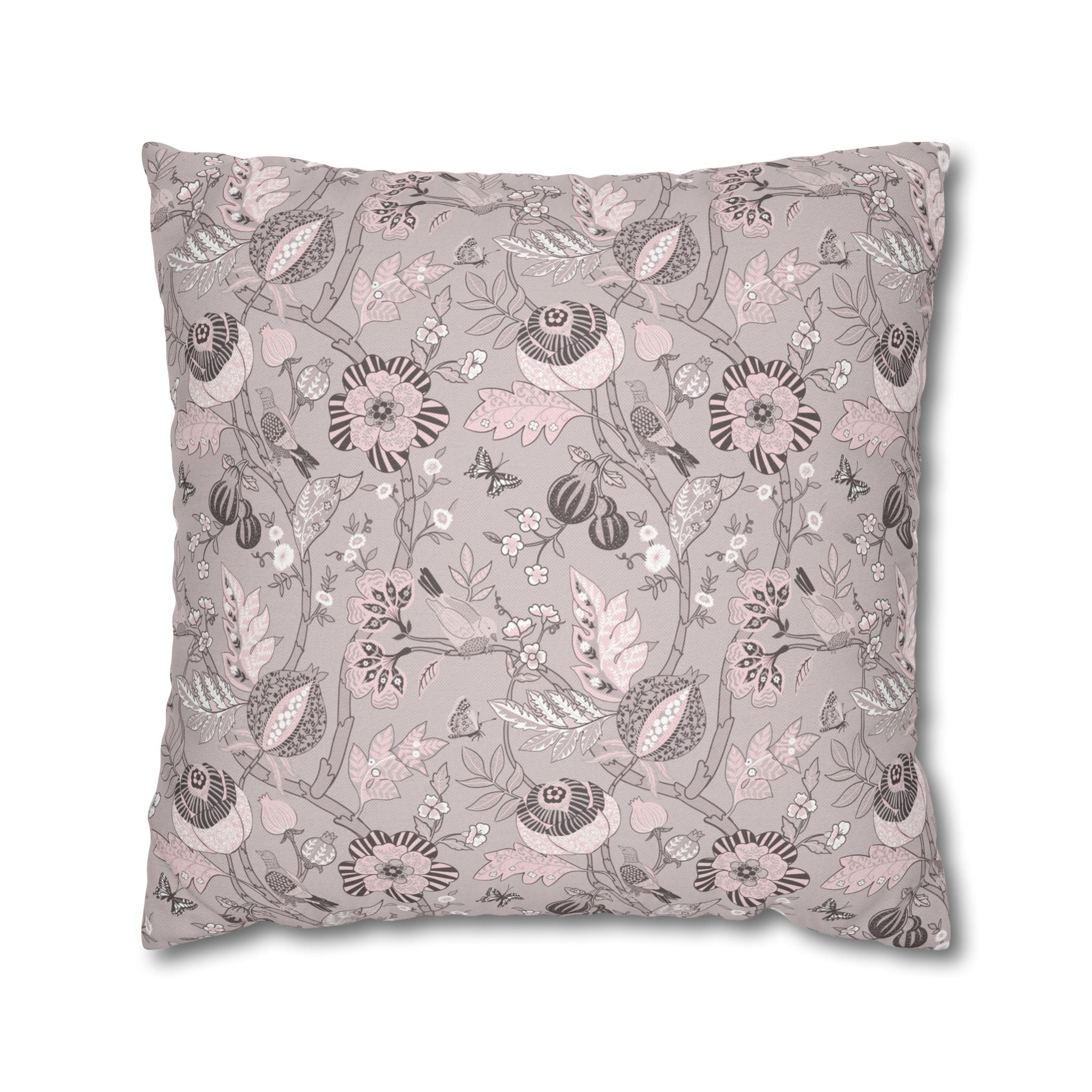 a square pillow with a repeating floral pattern in shades of pink and gray.