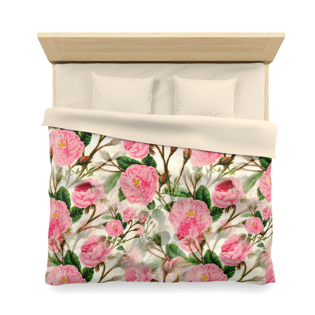 a bed with a floral print blanket and pillows. The blanket features a pattern of pink flowers and green leaves.