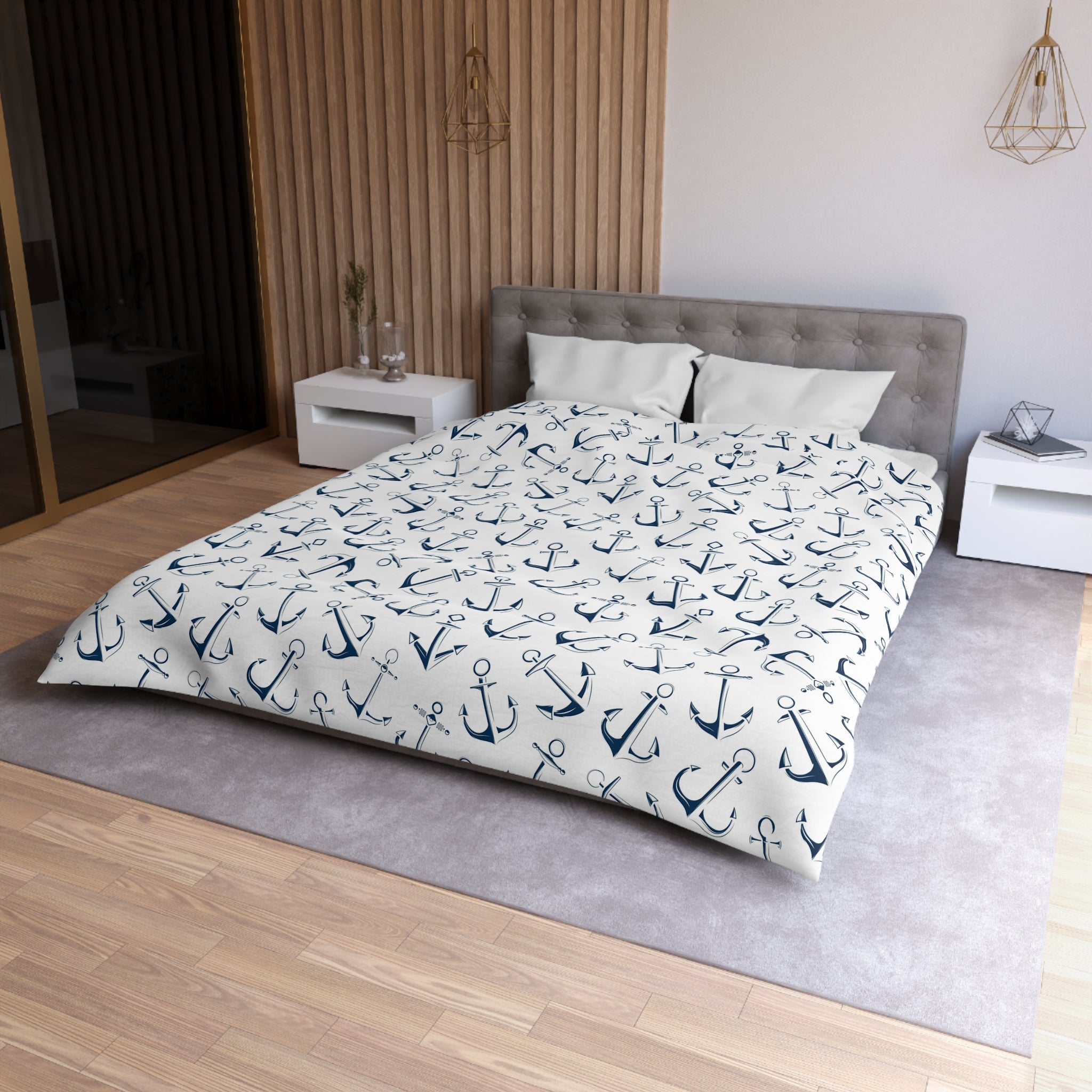 A modern bedroom with a large bed, white nightstands, and a wooden wall. The bed has a white comforter with a navy blue anchor pattern.