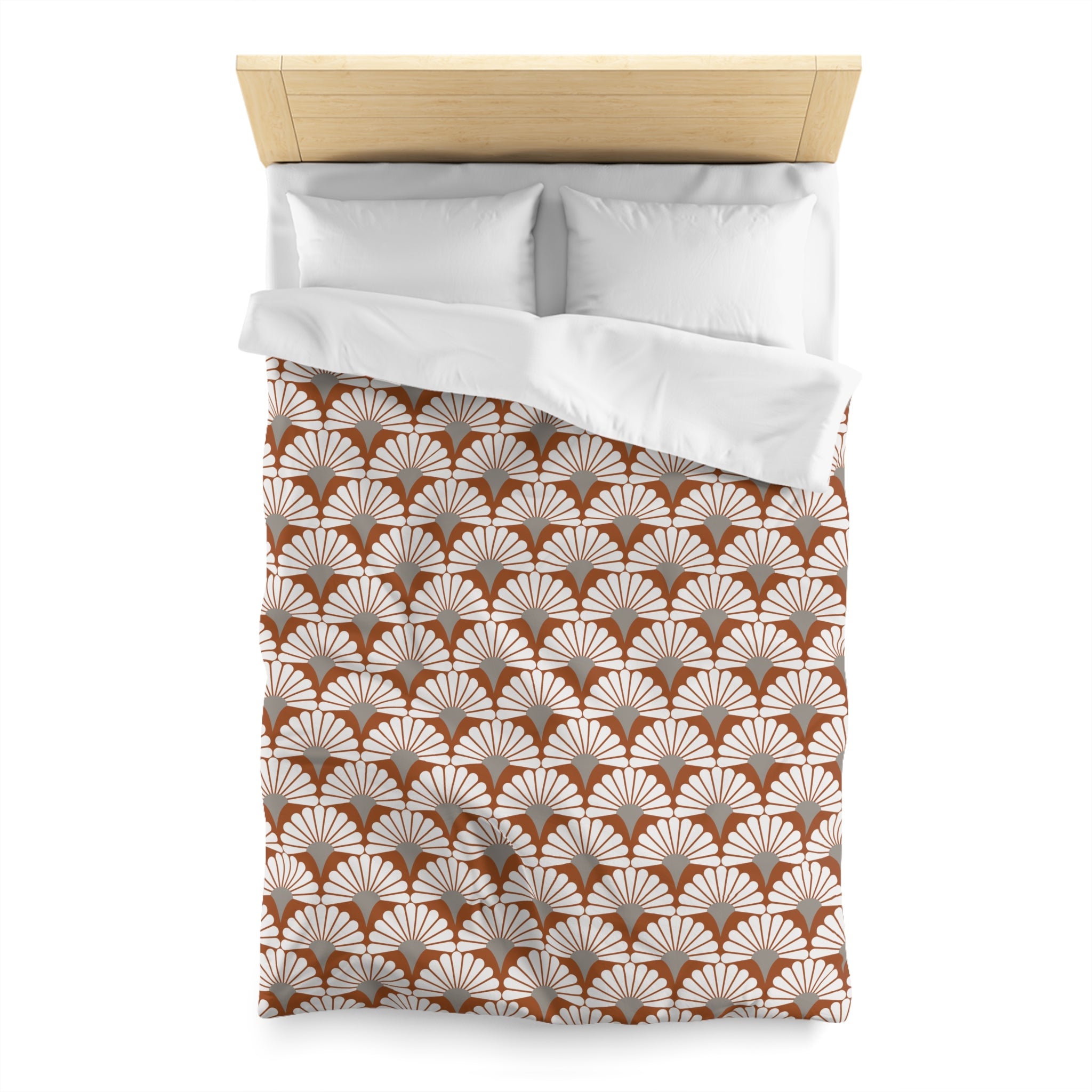 a neatly made bed with a white comforter and pillows. The comforter has a repeating pattern of brown and white feathers, creating a visually appealing and cozy appearance.