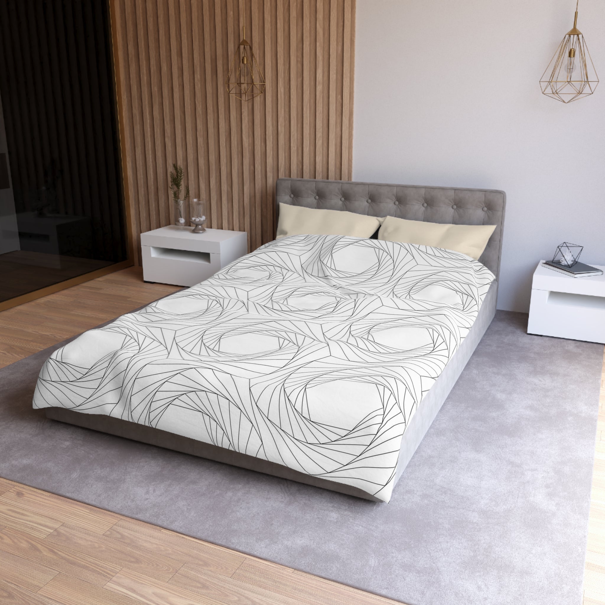 a modern bedroom with a gray tufted headboard, a white bedspread with a black and white abstract pattern, and a white nightstand next to the bed.