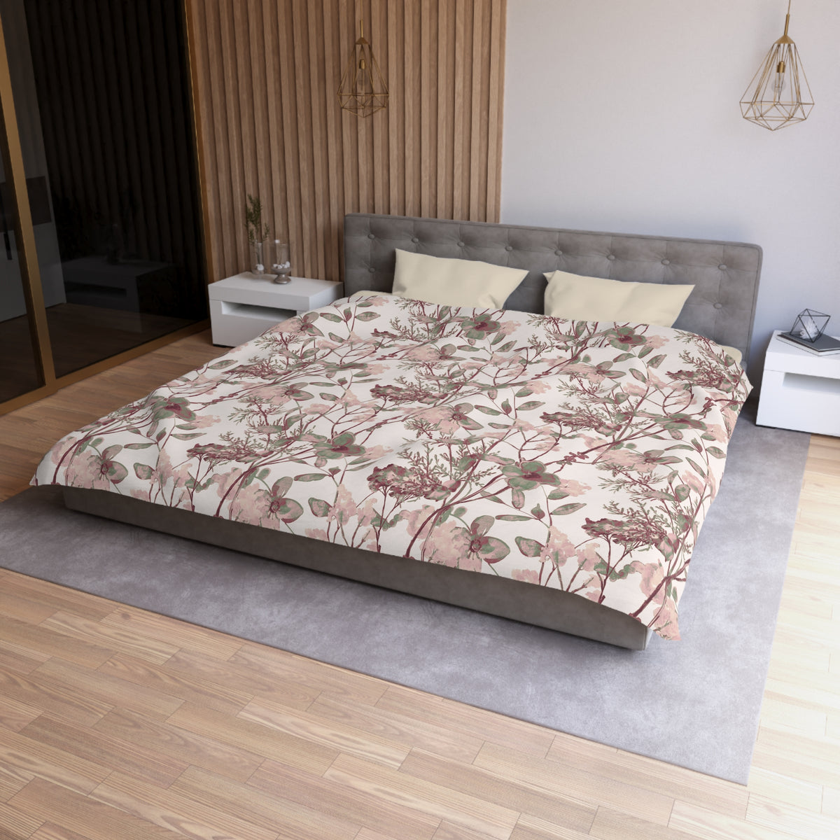 a modern bedroom with a large bed, a gray headboard, and a floral patterned comforter. The room has a wooden floor and white walls, creating a serene and elegant atmosphere.