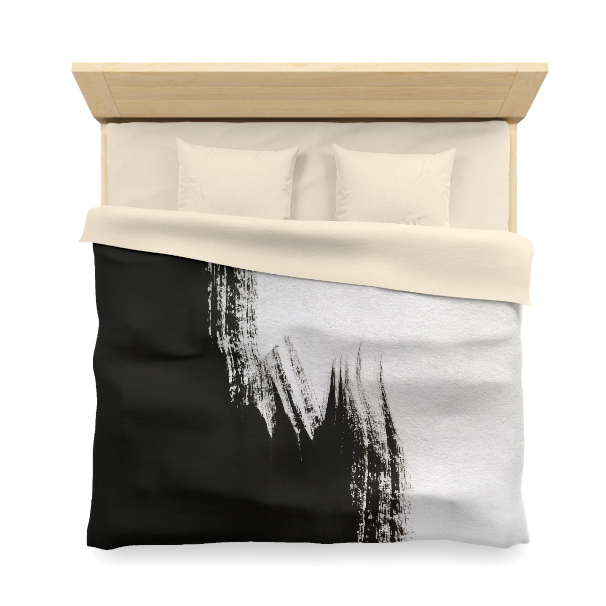 a neatly made bed with a black and white comforter featuring a bold brush stroke design.