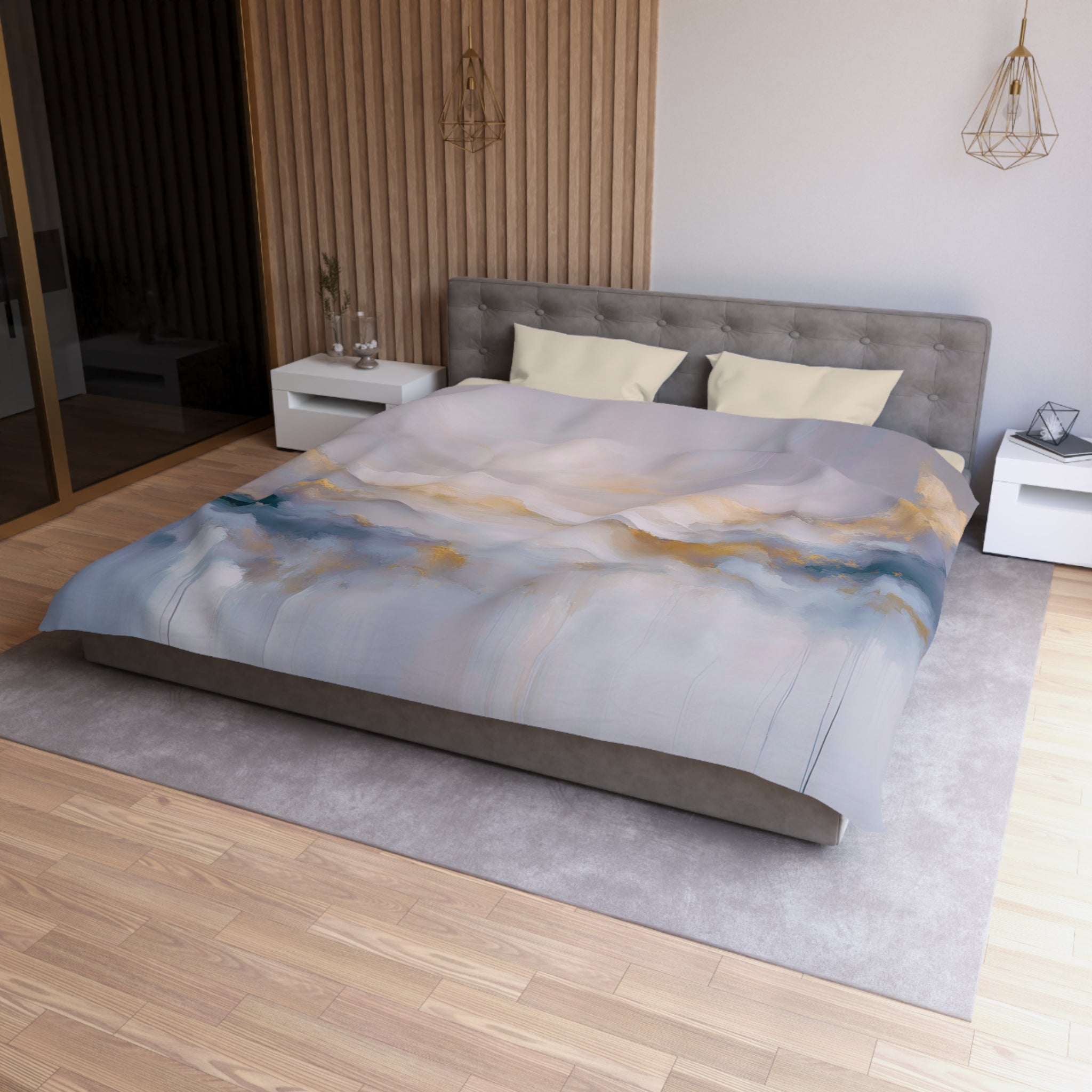 a modern bedroom with a large bed, a gray headboard, and a gray and white color scheme. The bed is covered in a gray comforter with a landscape design, and there are two white nightstands on either side of the bed. The room has a wooden floor and a gray area rug, creating a cozy and stylish atmosphere.