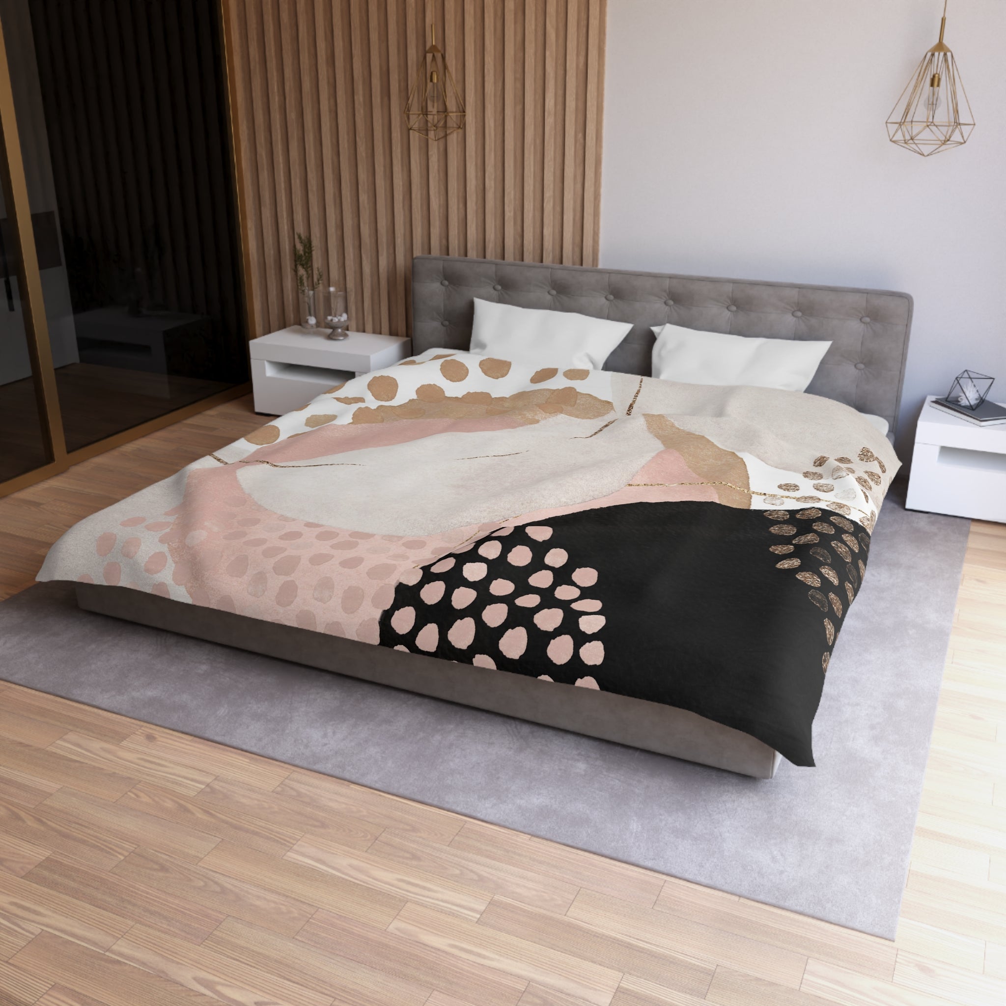 a modern bedroom with a large bed featuring a colorful, abstract patterned comforter and pillows. The room has a neutral color scheme with a wooden floor and white walls, creating a serene and stylish atmosphere.