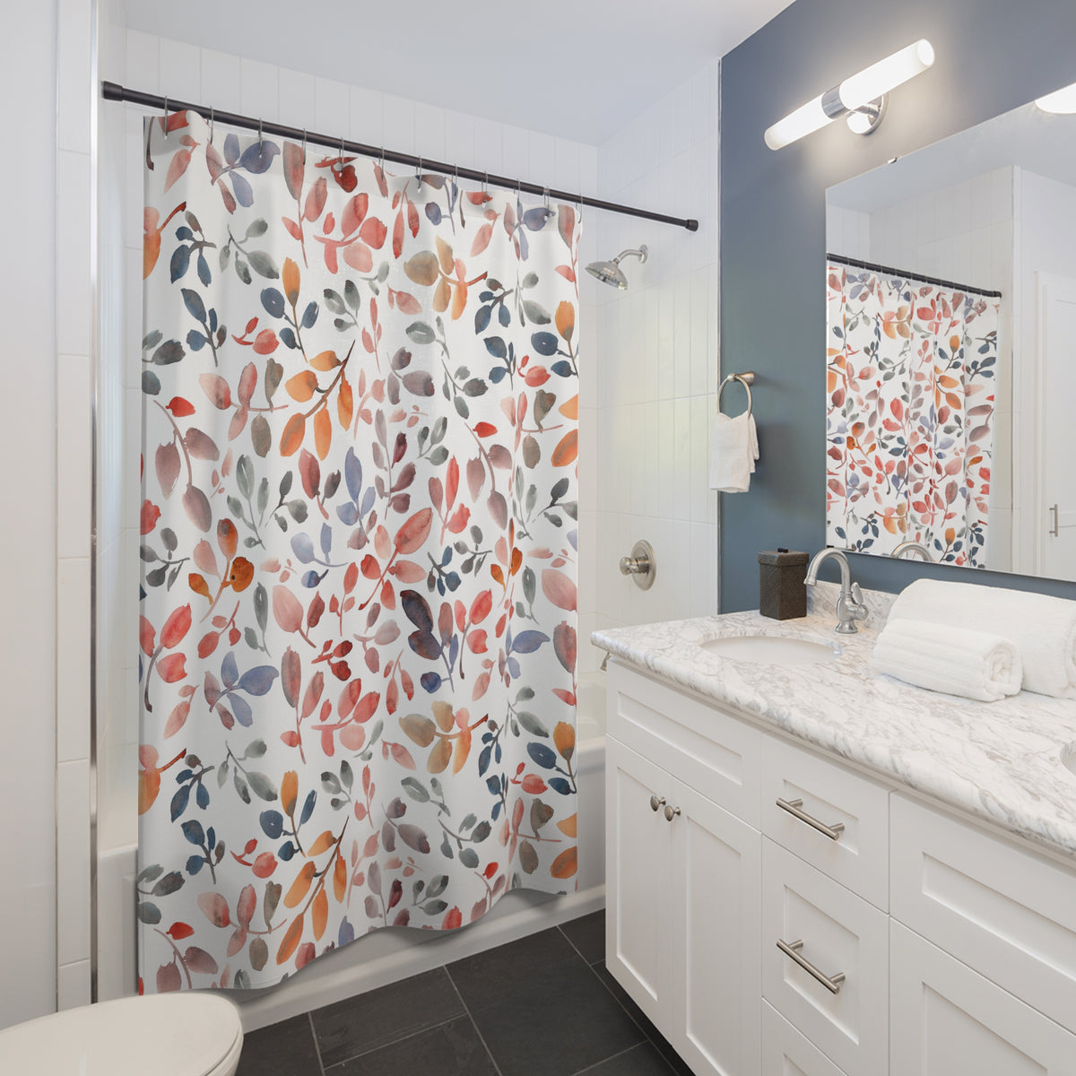 a modern bathroom with a white vanity, a colorful shower curtain featuring leaves and flowers, and a mirror above the vanity.