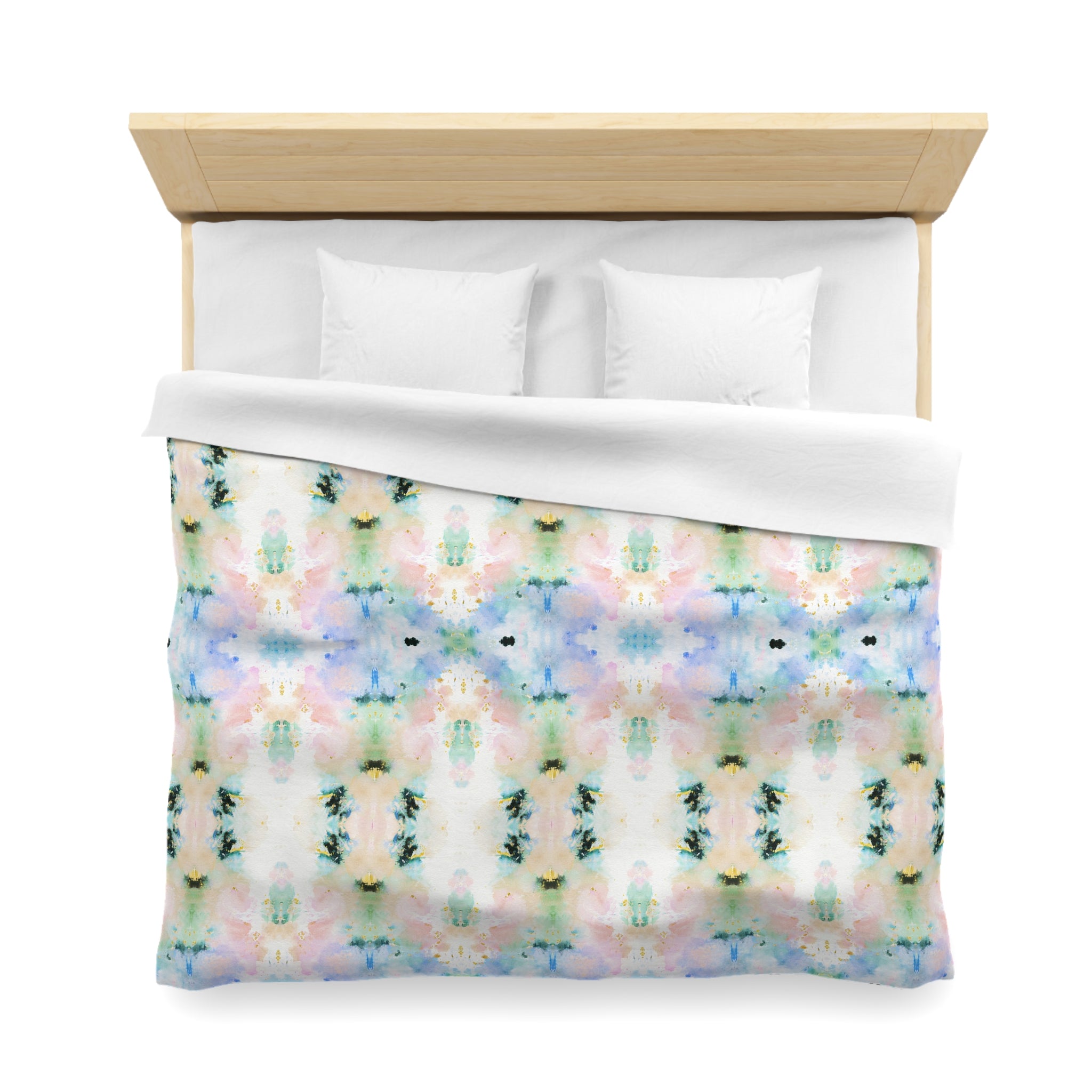 a bed with a colorful, abstract patterned comforter and pillows.