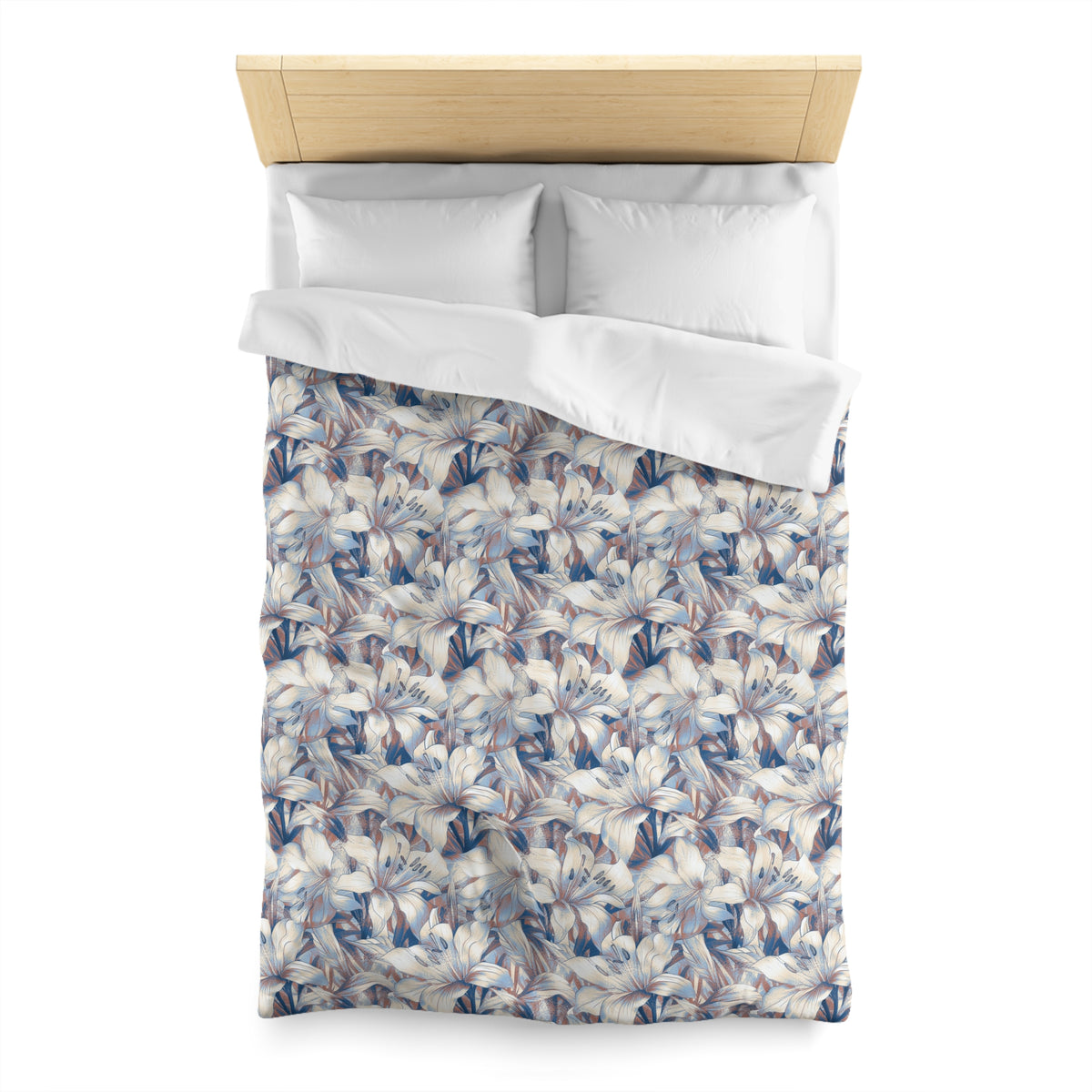 a neatly made bed with a floral patterned comforter and pillows.