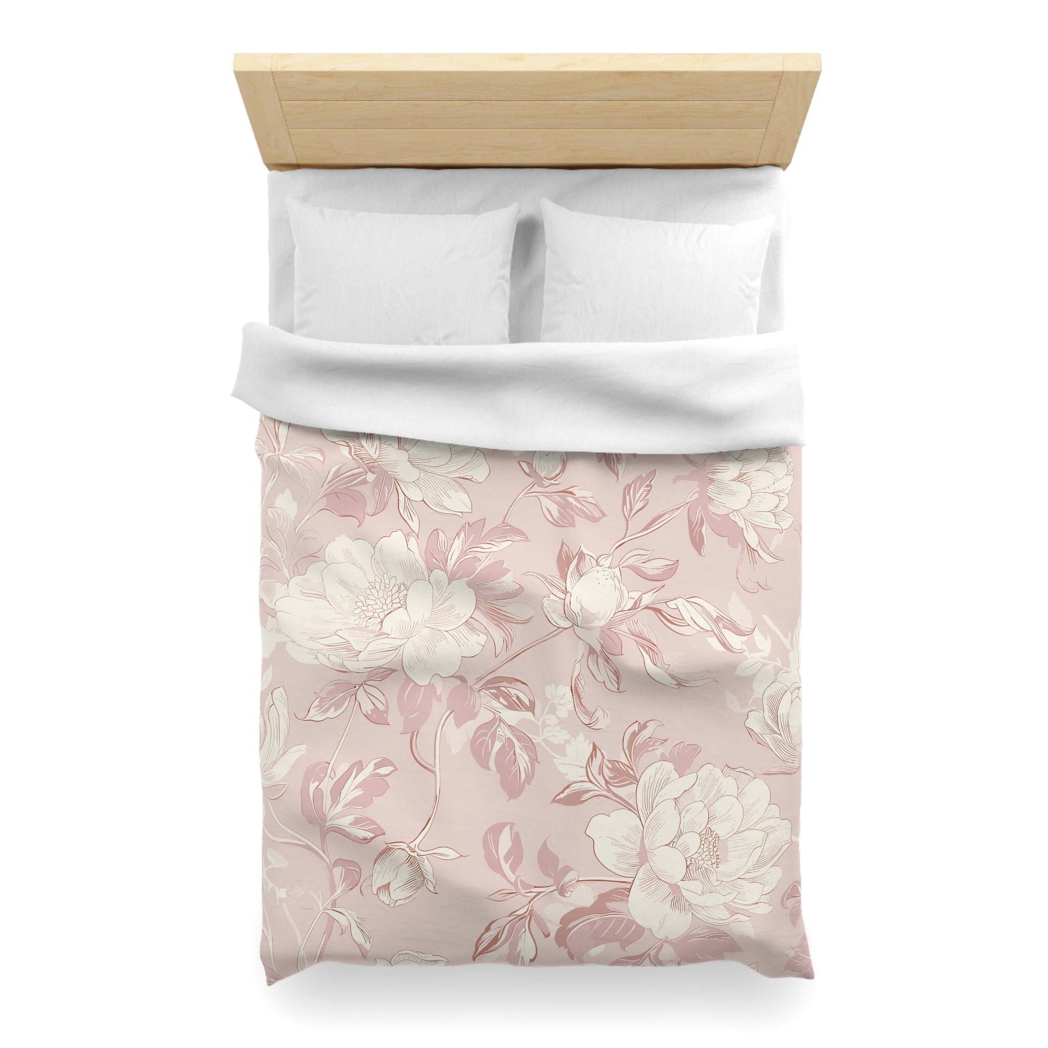 a neatly made bed with a floral patterned comforter and pillows.