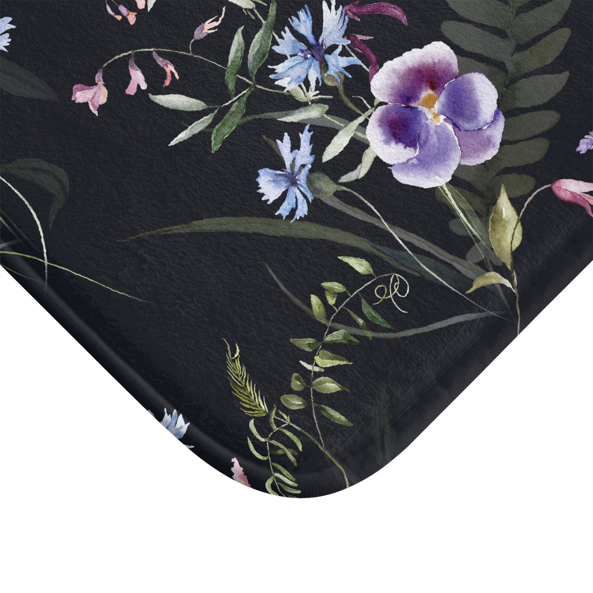 a black surface with a floral pattern of purple and blue flowers, along with green leaves and ferns.