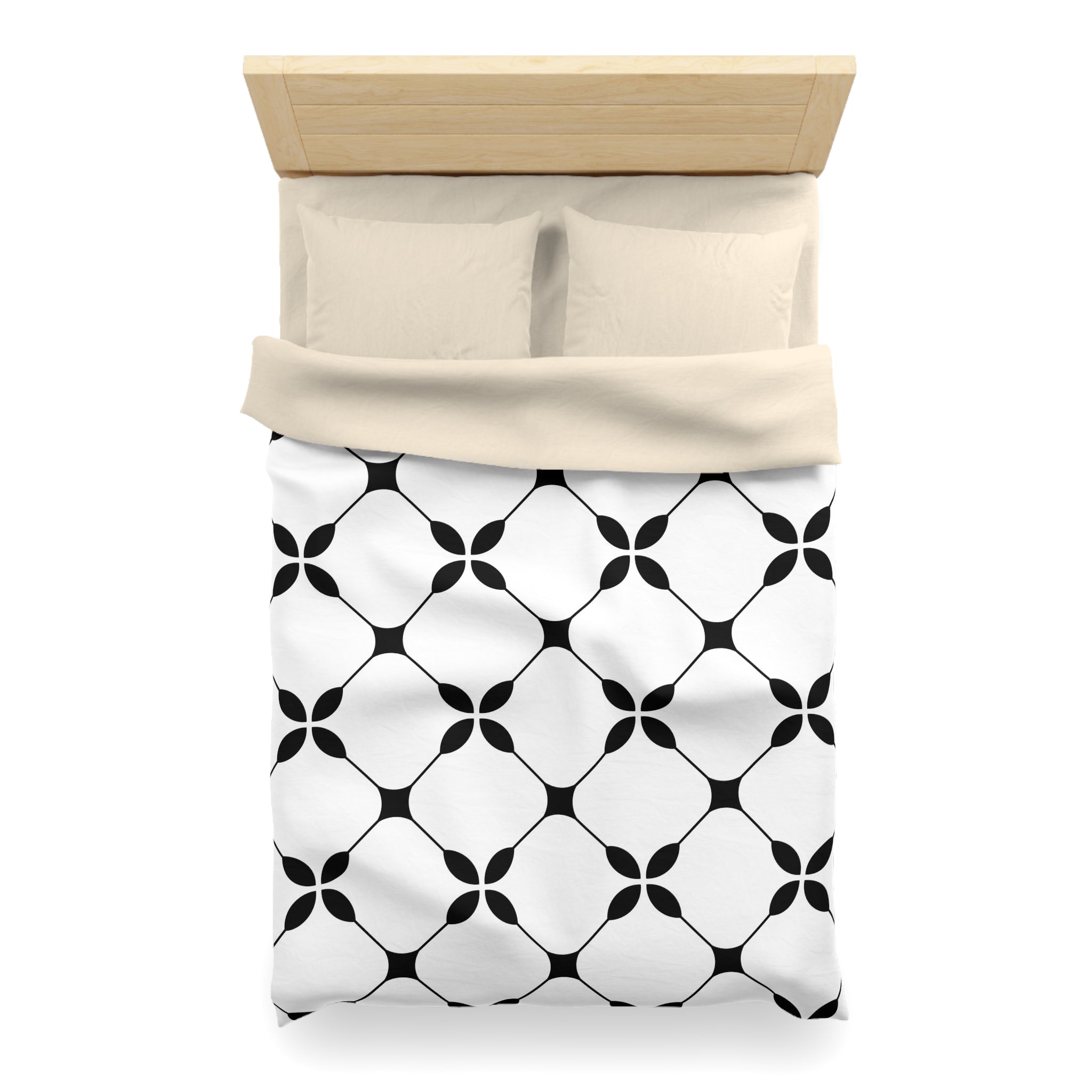 a neatly made bed with a black and white geometric patterned comforter and pillows.
