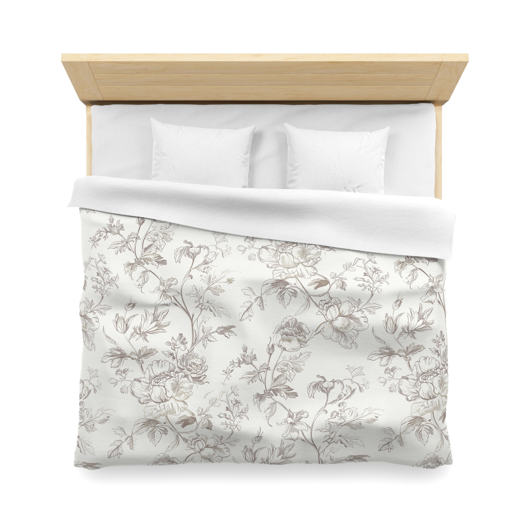 a neatly made bed with a floral patterned comforter and two pillows.