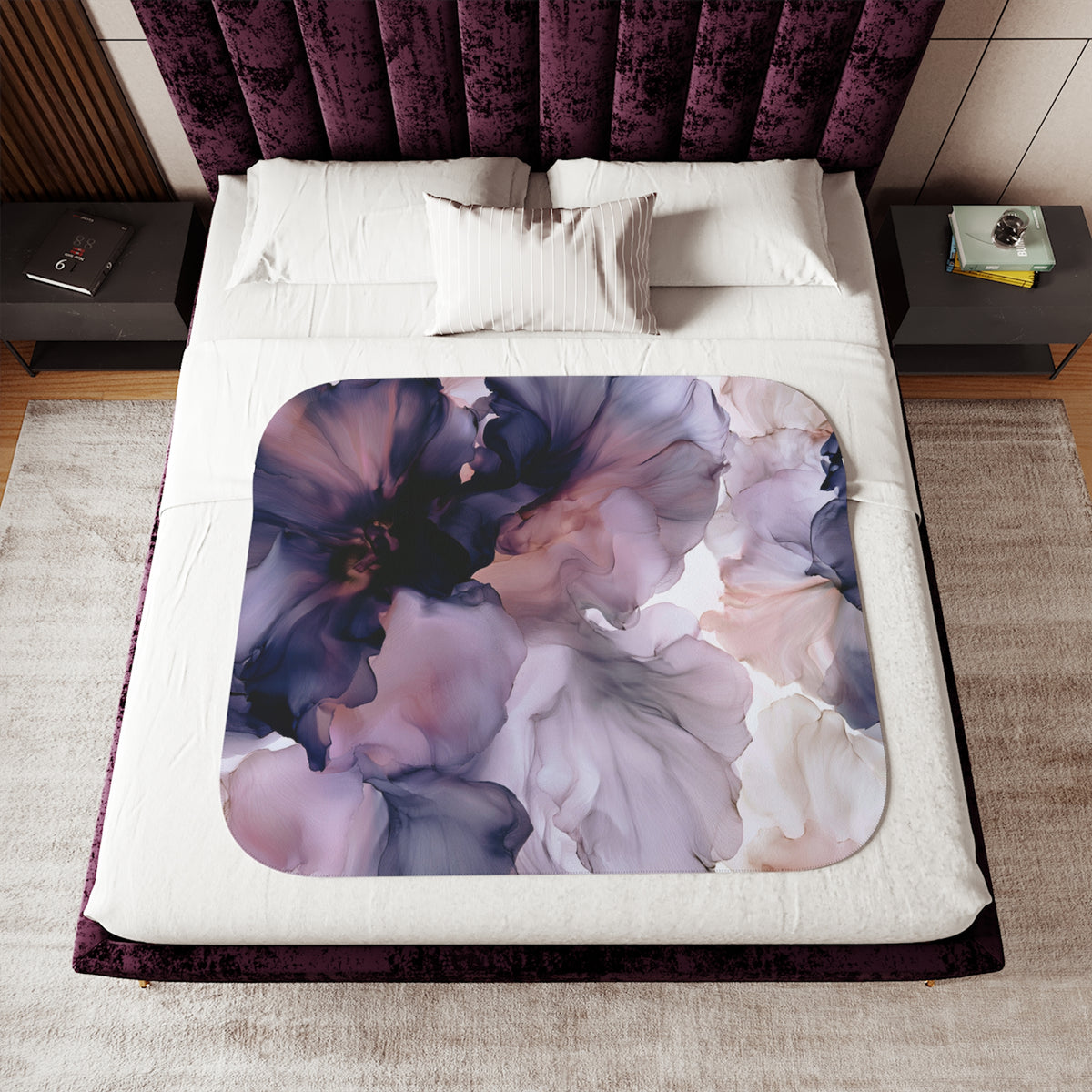 a bed with a purple flower comforter on top of it